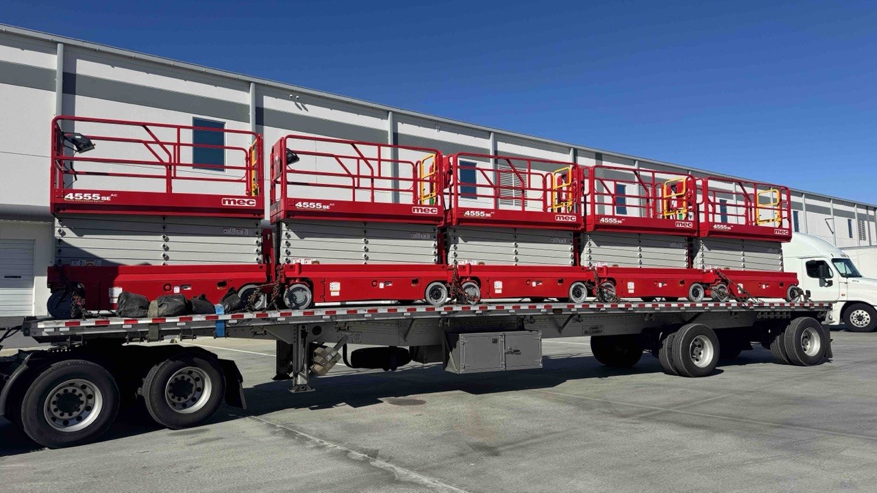 Warehouse lifts and material handling equipment transported on a flatbed.