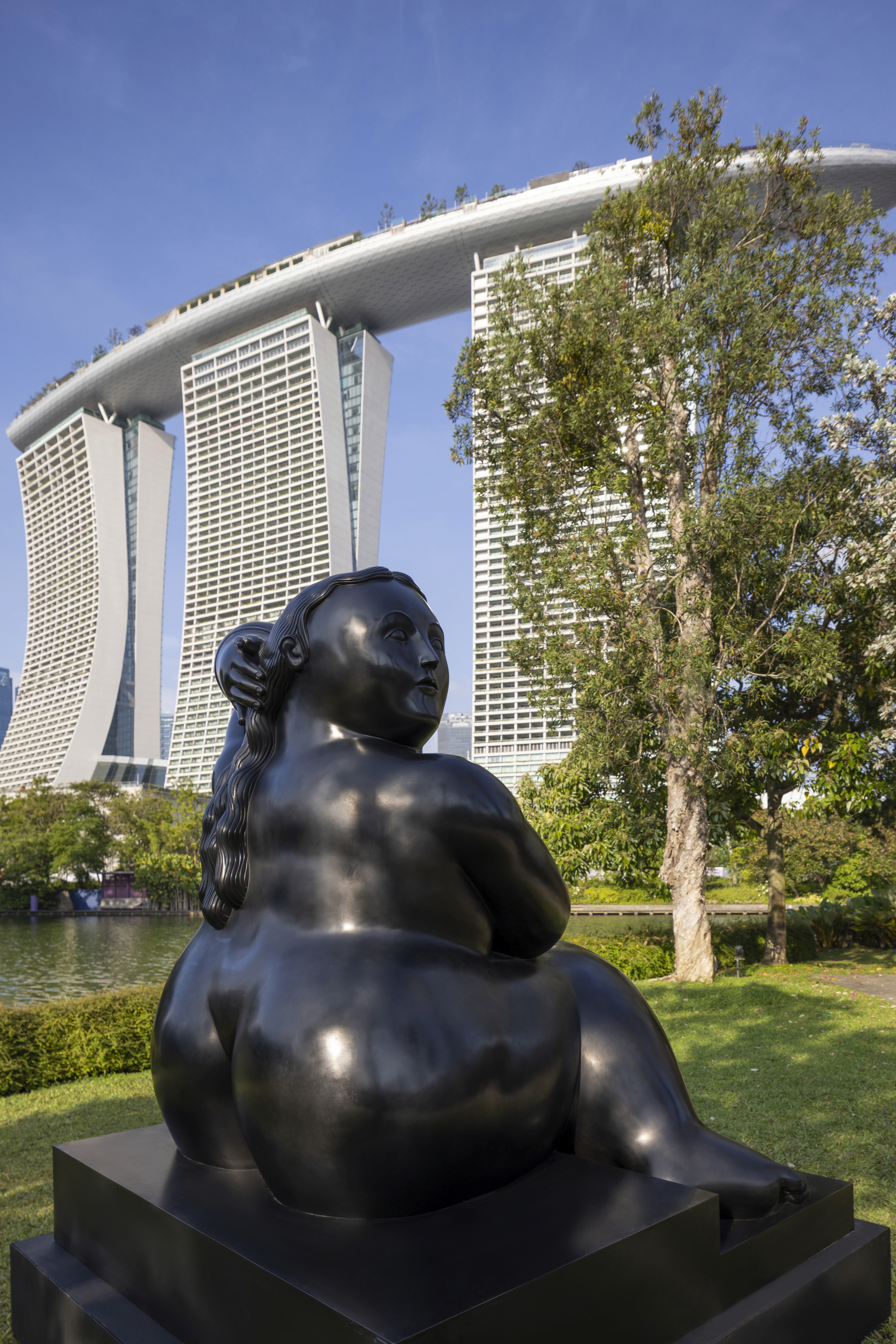 Two hands in an elegant gesture, one above the other, against a dark background