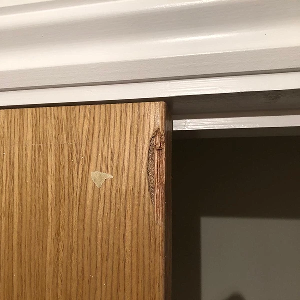 Chipped IPS wall panel before repair in Dubai