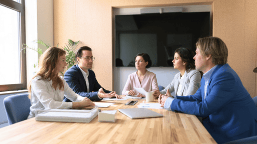 A consultant participating in a team meeting, providing fractional AI advisory support alongside company leaders.