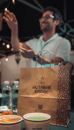 Barista in mask preparing coffee with moka pot