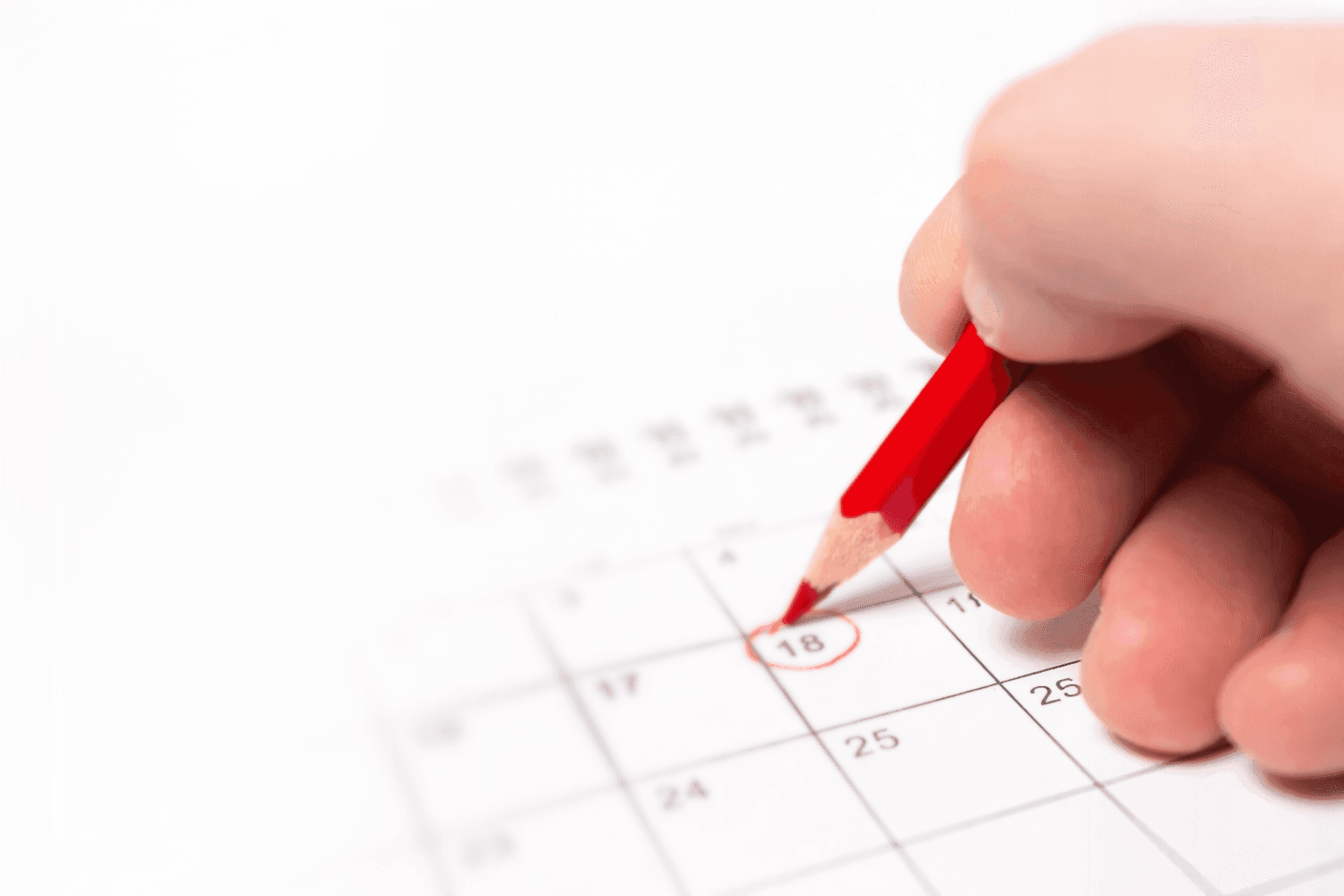 grey and black pen on calendar book