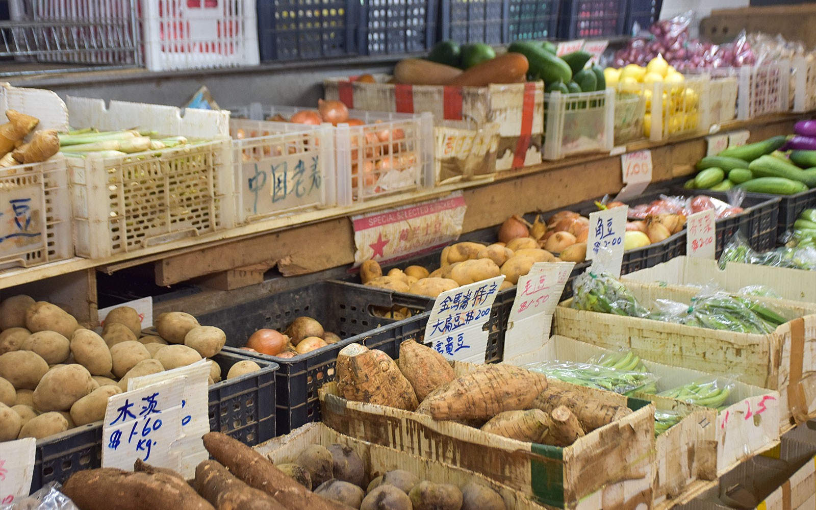 Singapore market tour with chef selecting fresh produce for culinary experience.