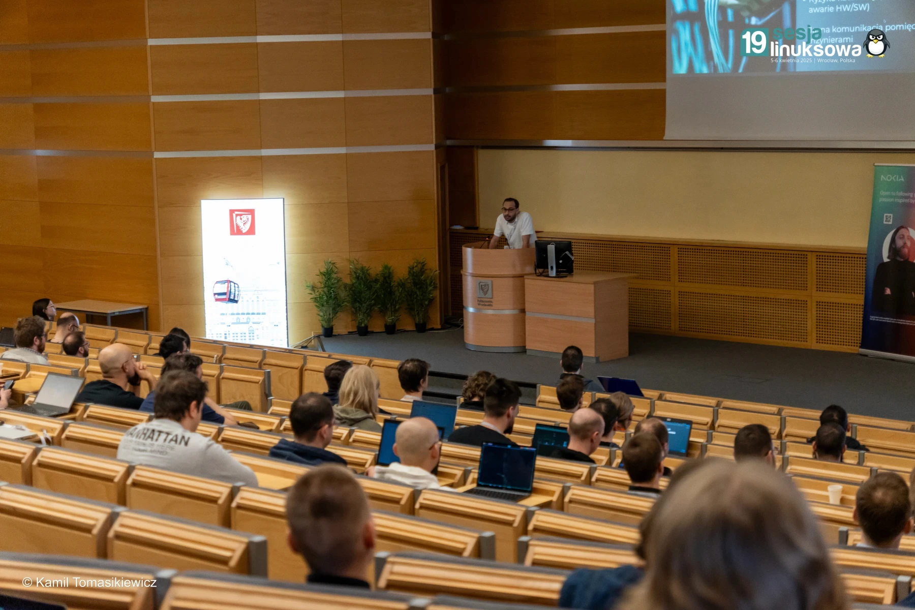 BecomeDevops trainer speaking to an audience in a conference hall