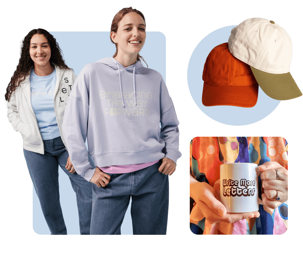 Two smiling women wearing custom t-shirts and hoodies, colorful hats and a mug.