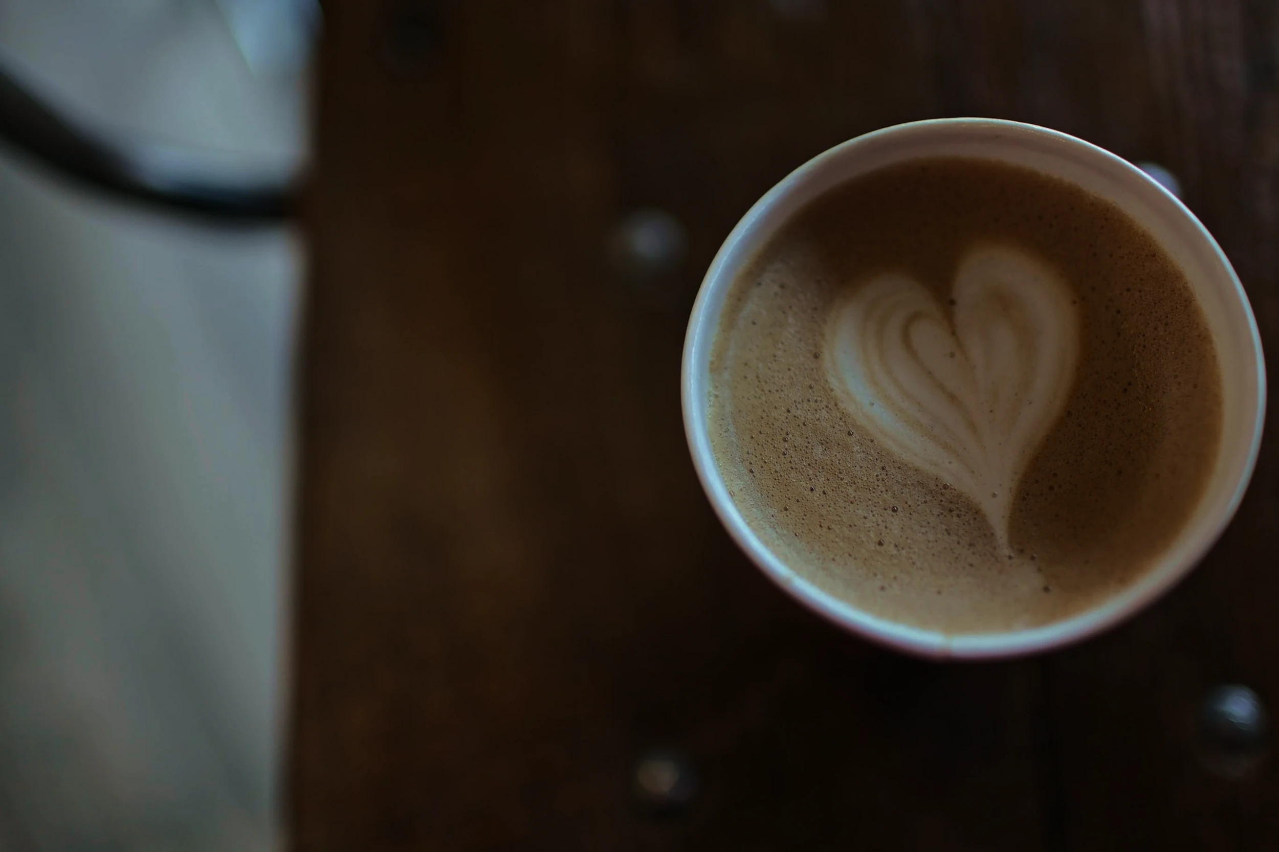 An aesthetic image of a latte with a heart in the foam