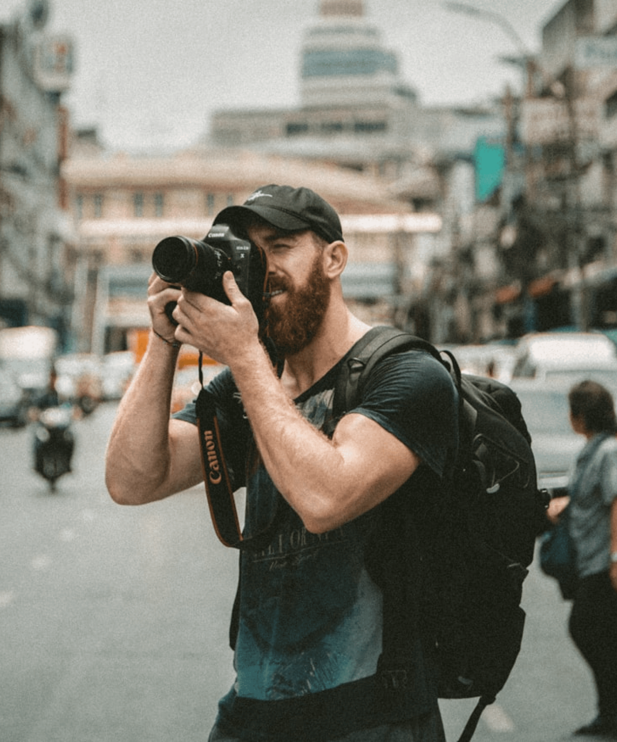 Photographer man holding a camera in a crowded city