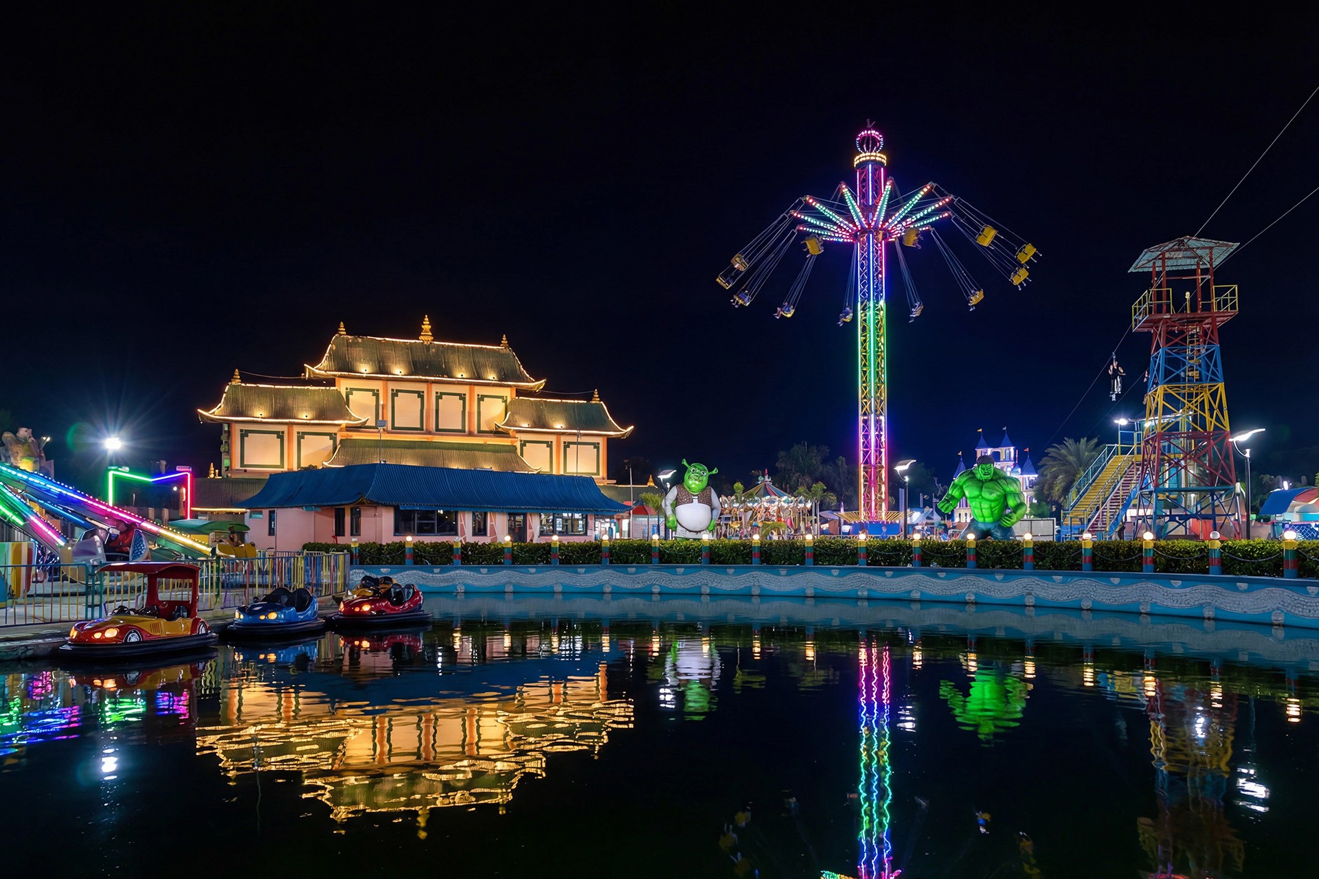 Cozy orange velvet lounge chair by glowing lamp.