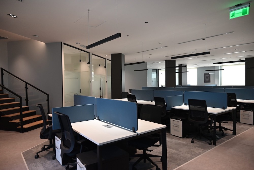 Open office workspace with shared desks at DIOM Black Garden headquarters in Riyadh