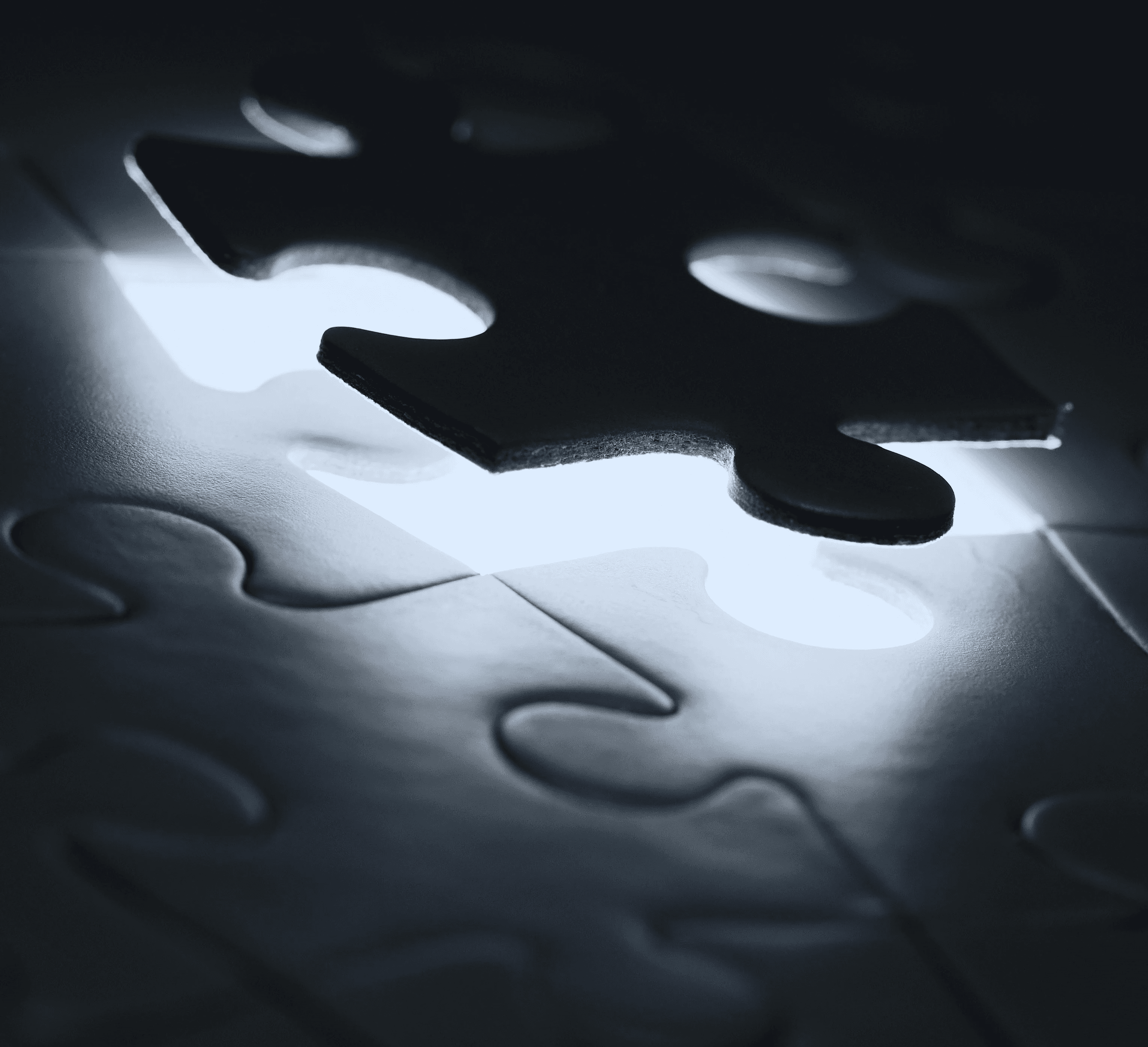 black puzzle piece on white paper