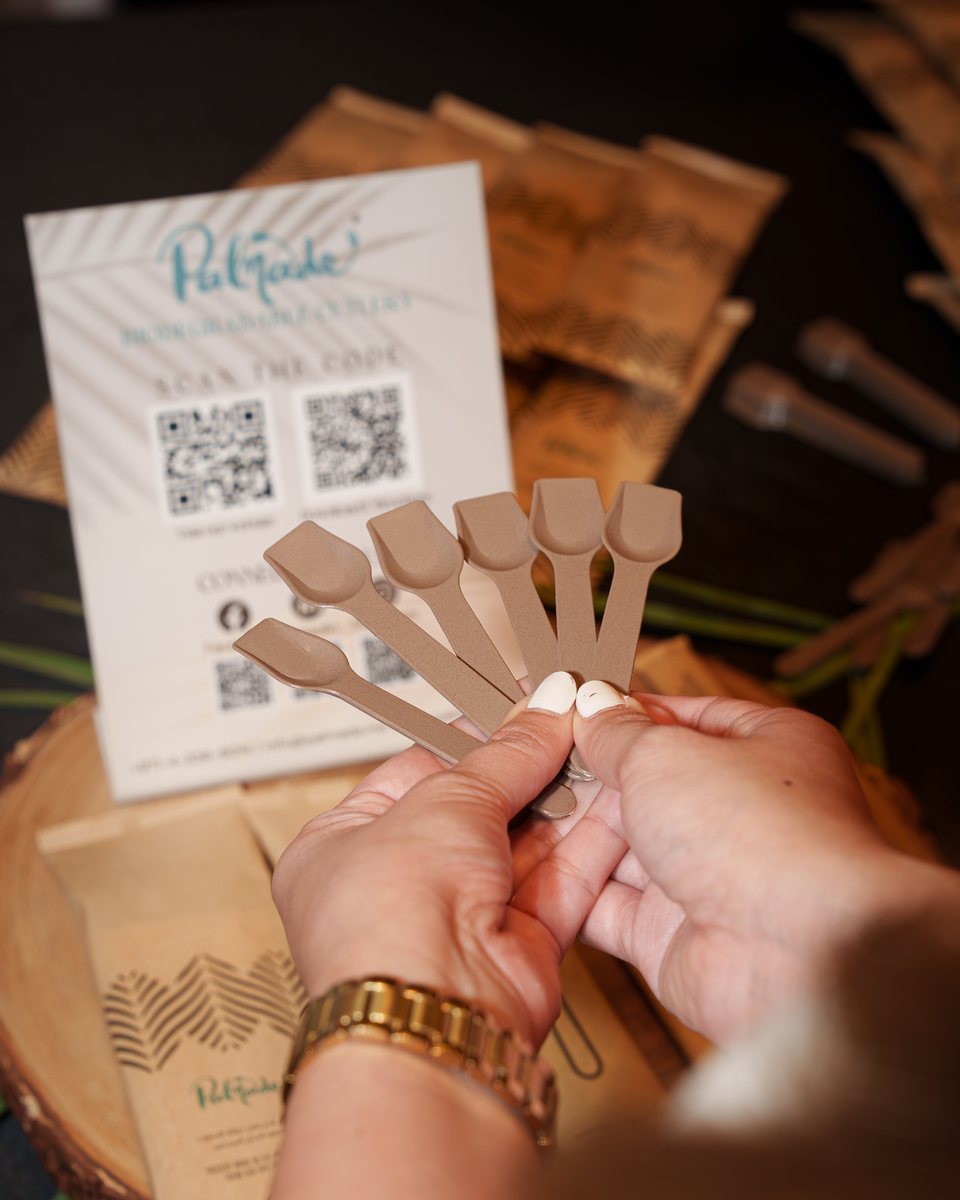 Hands holding Palmade tasting spoons