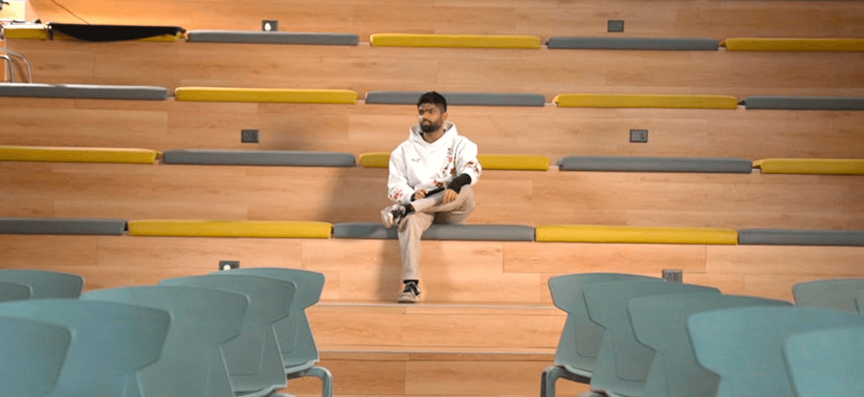 Person, holding a white rose behind his back with one arm on a light blue background