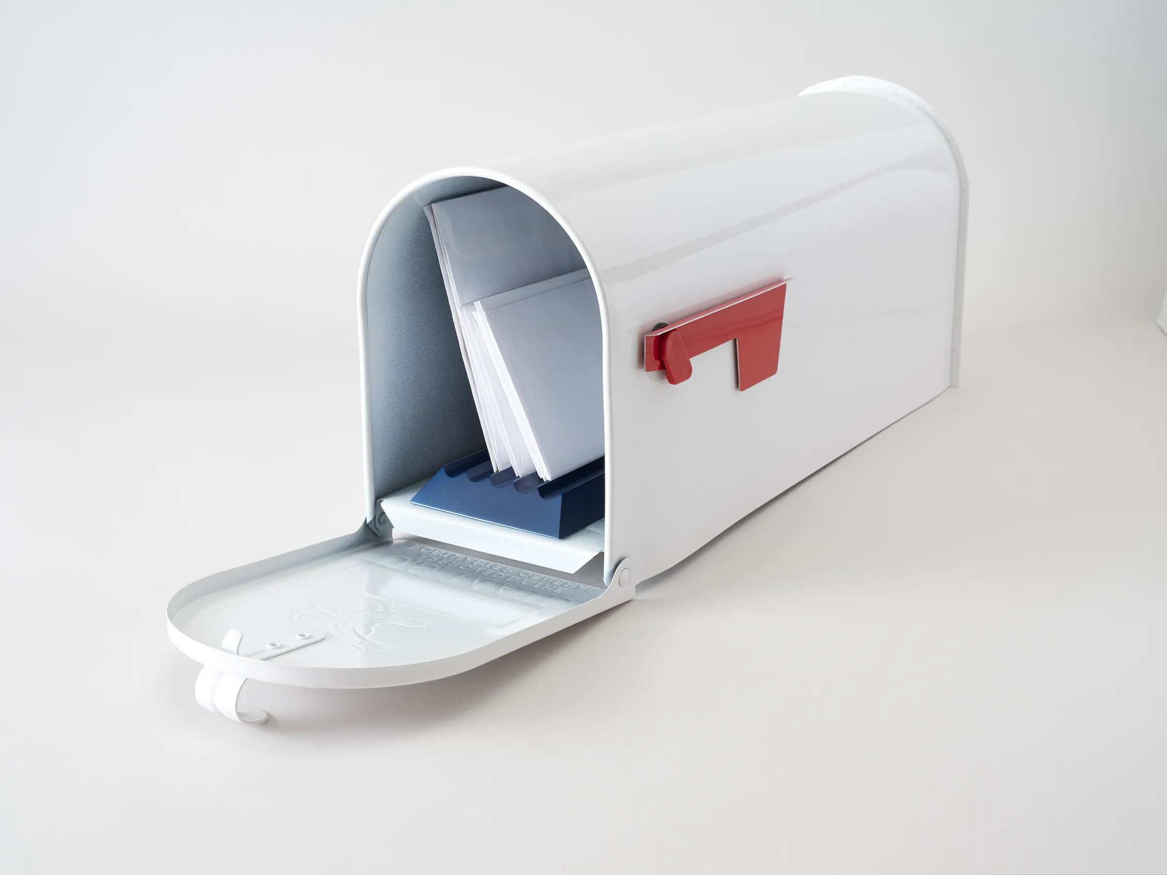 White residential mailbox with the USPS sensor installed beneath the mail inside
