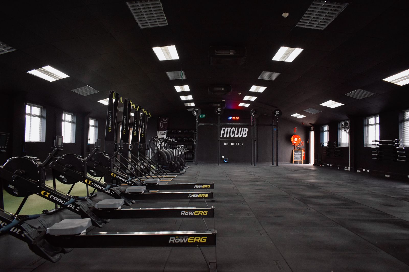 Main training area at FitClub Technopark featuring members participating in functional fitness workouts while a coach guides and supports training sessions in Stellenbosch.