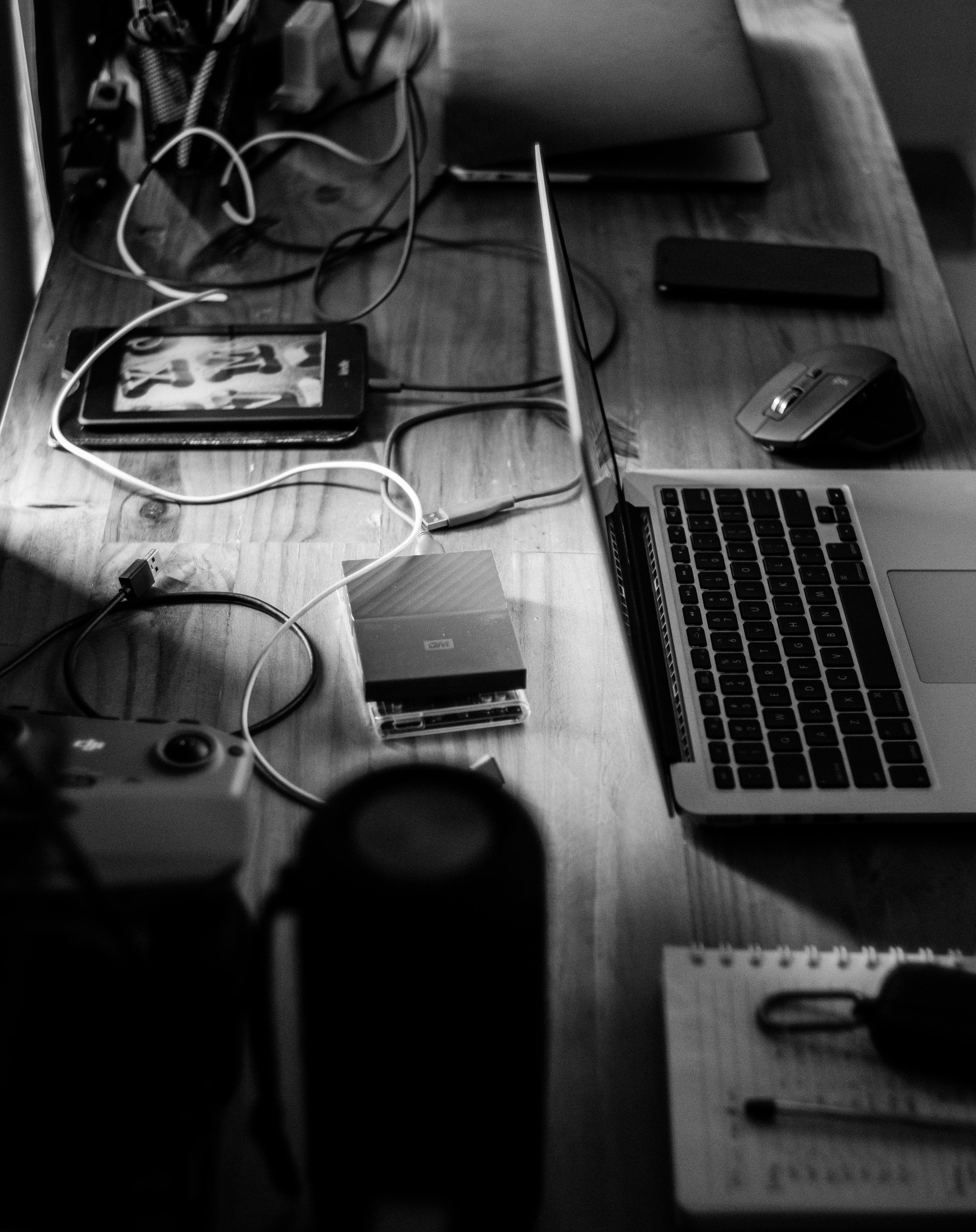 Black and white photo of a cluttered desk