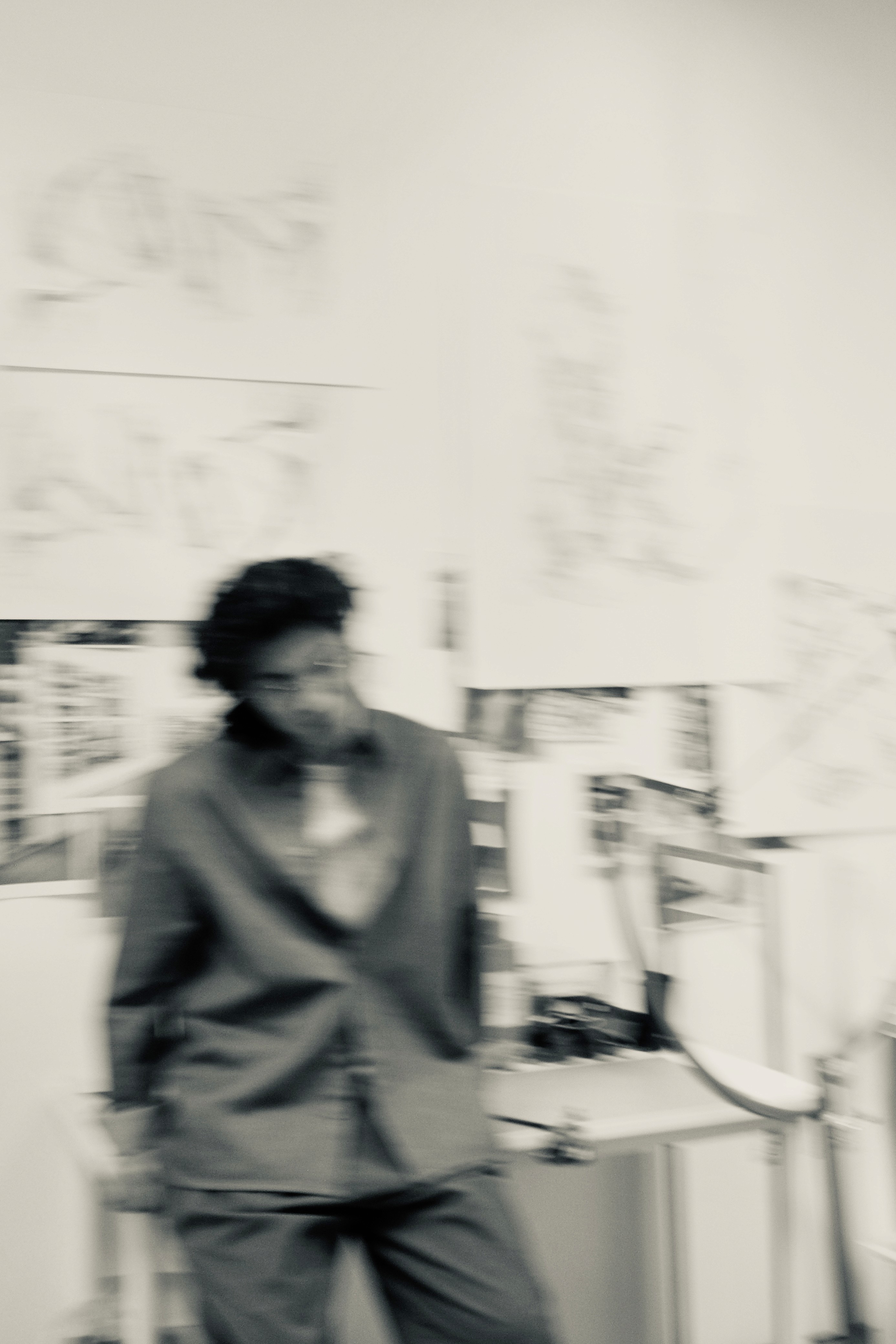 a blurry photo of a person standing in front of a wall