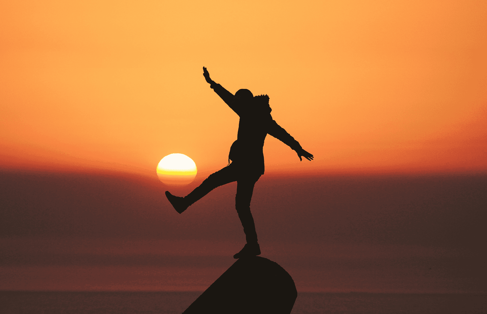 Person balancing on a rock