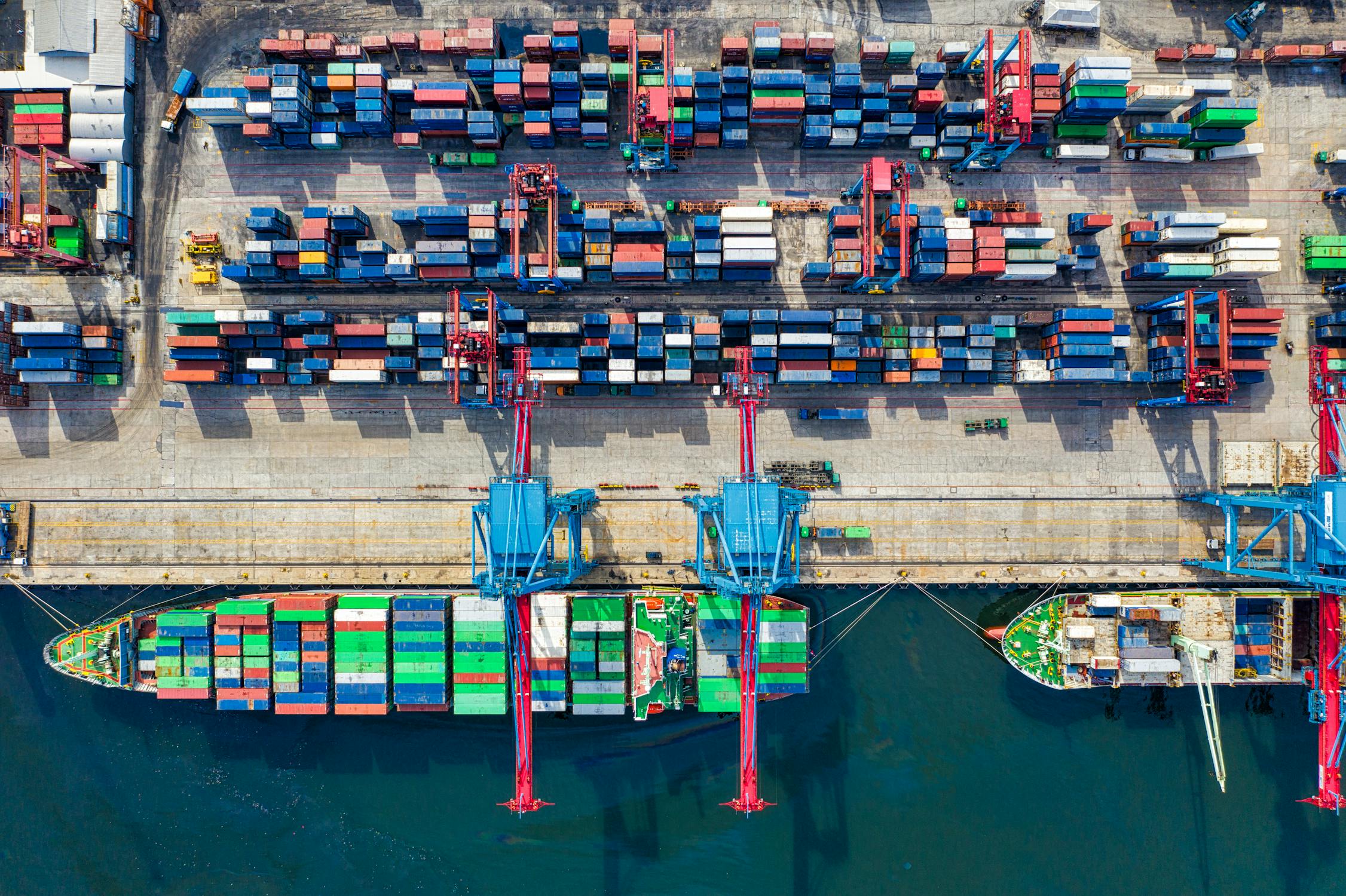 Shipping containers at a busy international port representing global supply chains