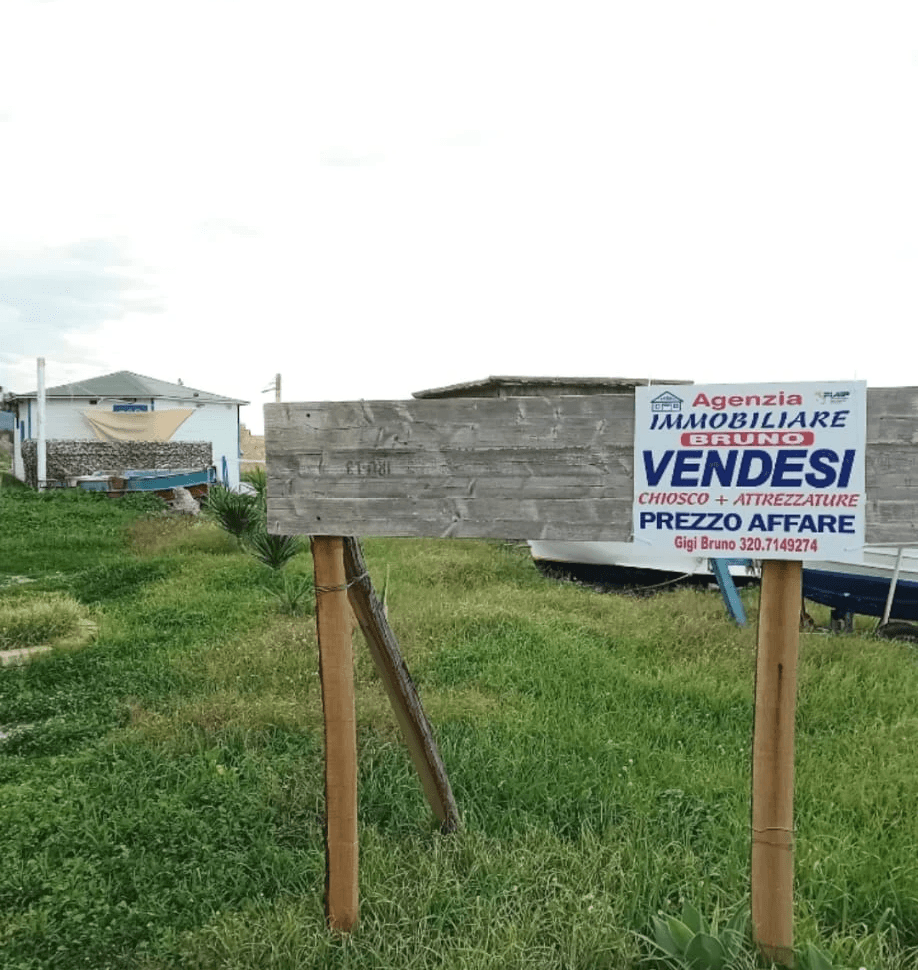 A modern brick house with a two-car garage, well-manicured lawn, and clear blue sky in the background.