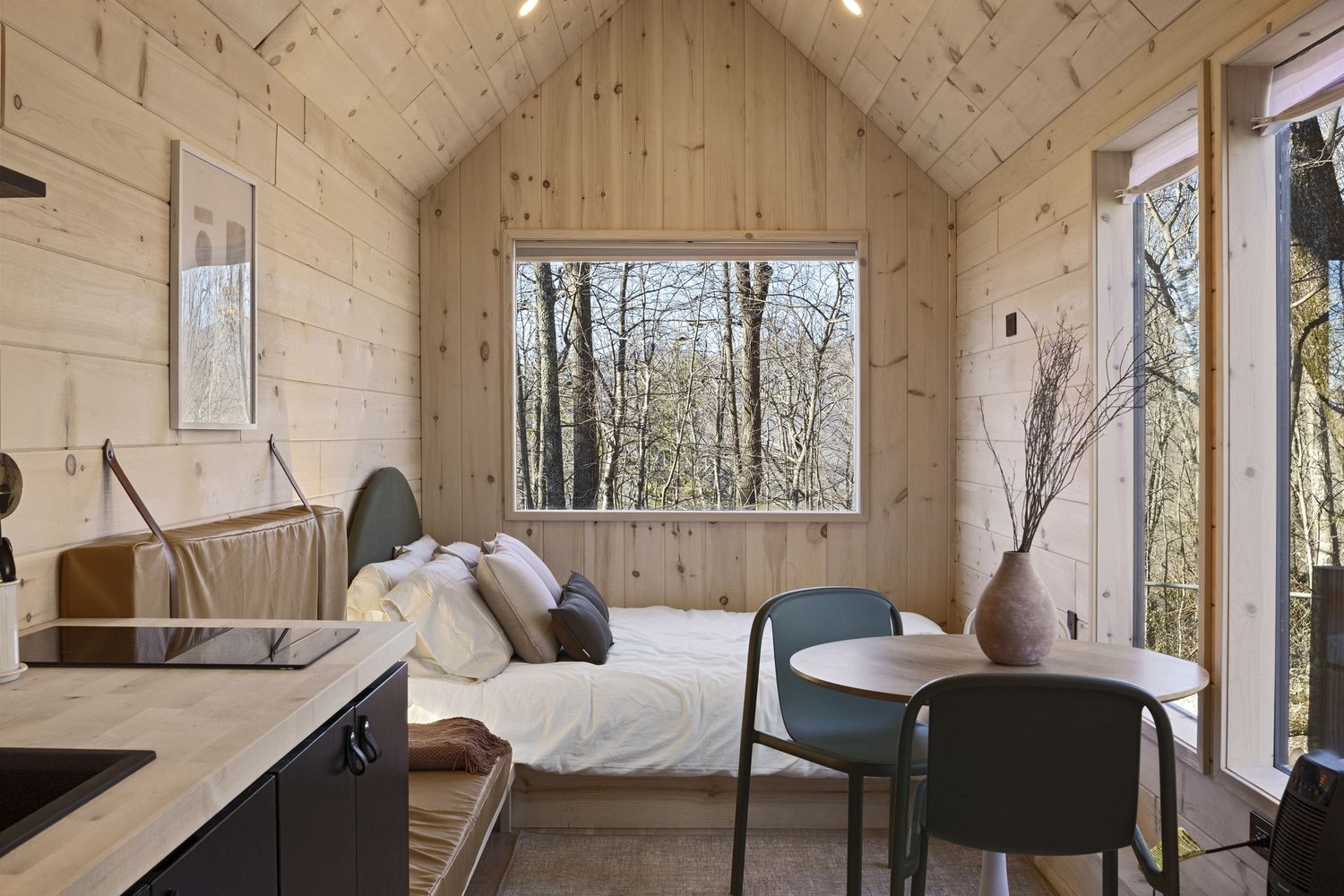 Comfy Bed with picturesque window in Nordic & Spruce's The Weekender