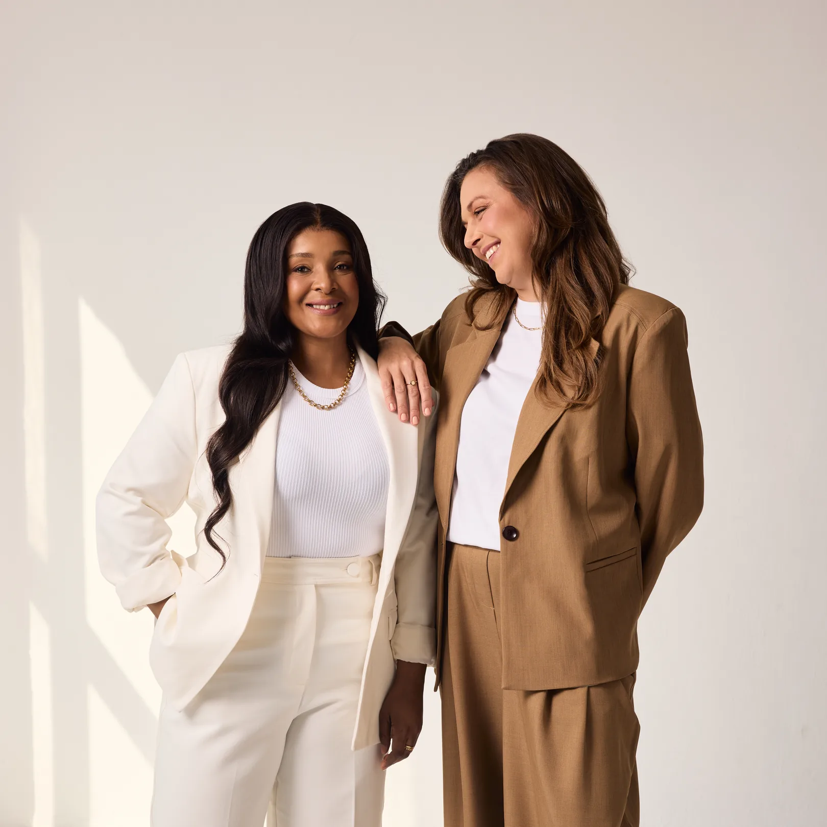 Sēkret founders Roz and Zola standing together in a bright studio