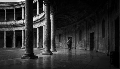 Houses glowing orange near a lake with mountains in the background