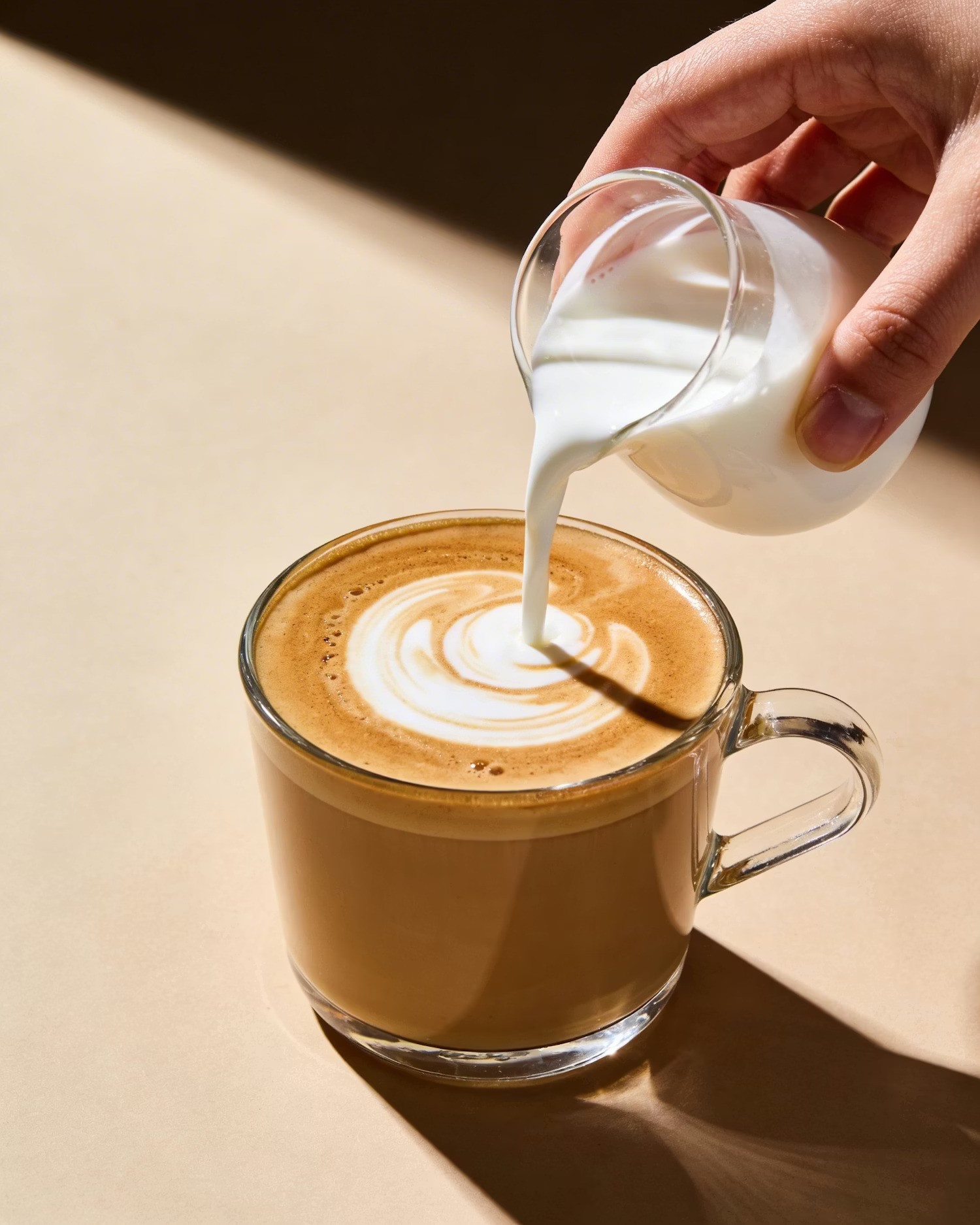 Warm latte in a ceramic cup, representing nourishing morning rituals and hormone-supportive nutrition
