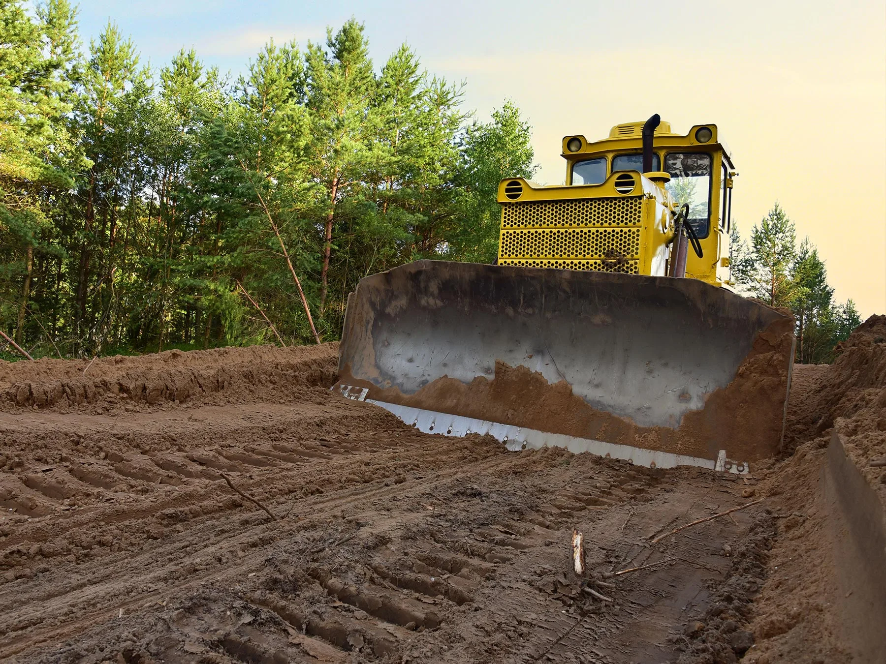 Bulldozer performing fine grading to establish proper slope and drainage in Kansas City