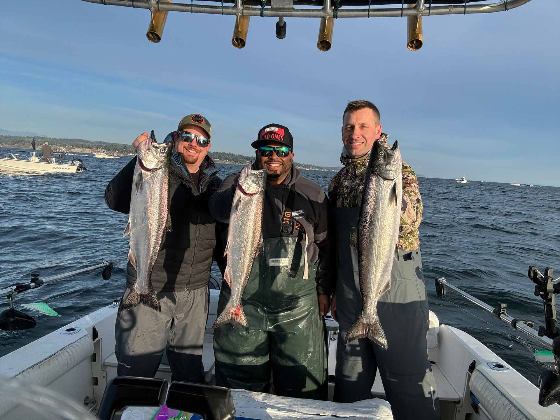 Charter boat captains holding their caught fish