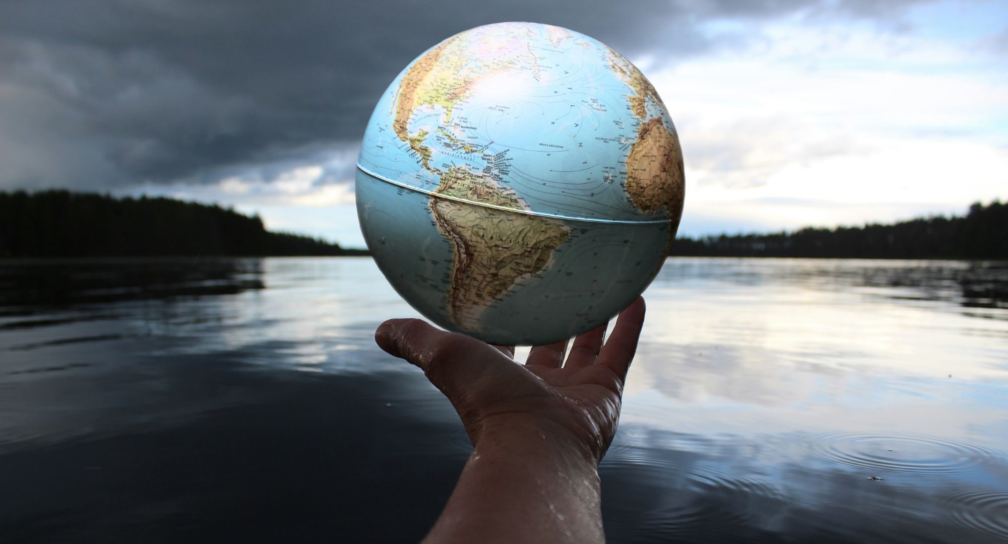 mão segurando um globo terrestre