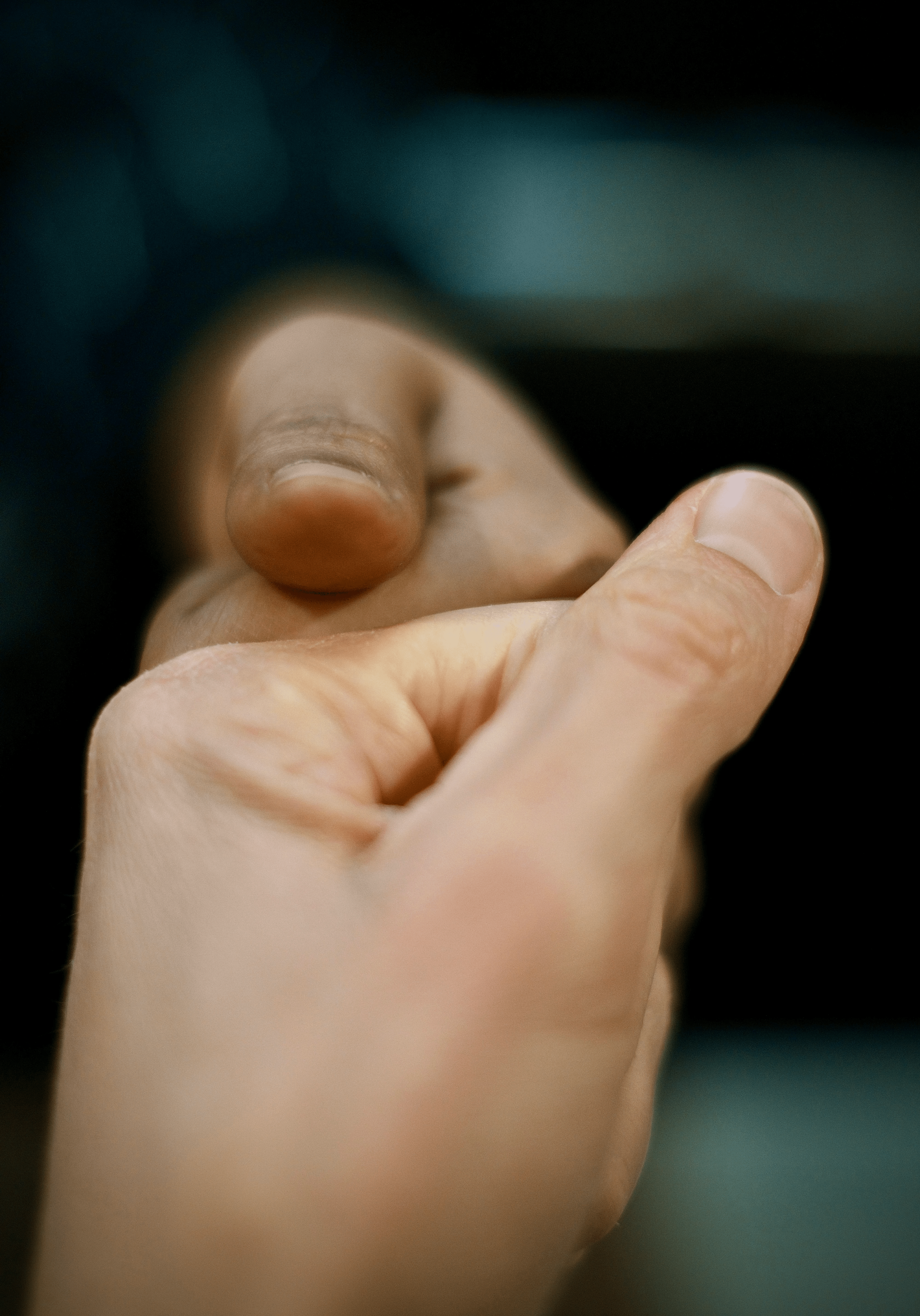 A close up of a person holding something in their hand