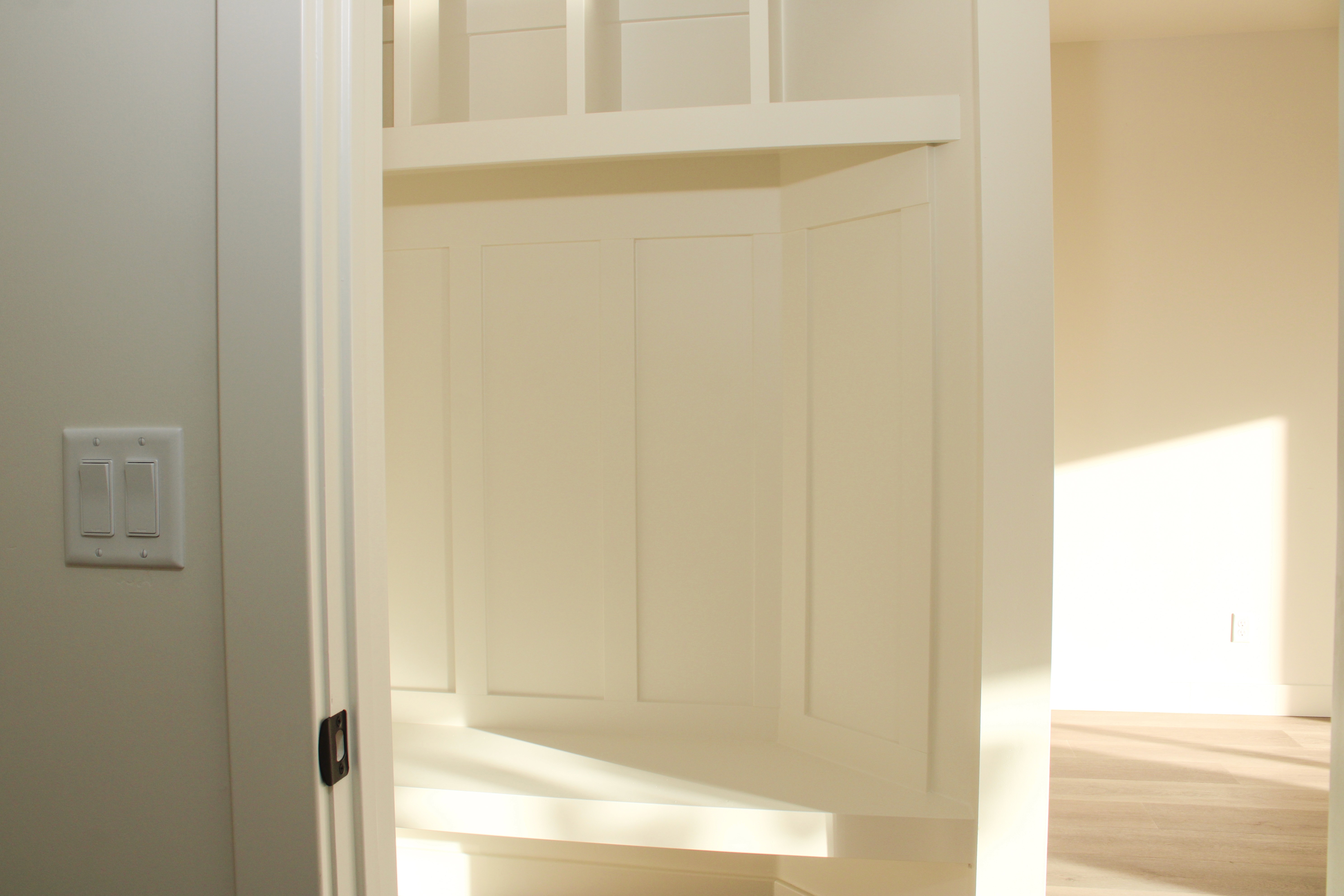 Garage entry mudroom bench inside the Golden Hour home in Hurricane, Utah, featuring a custom Madsen Homes built-in bench and storage for everyday organization.