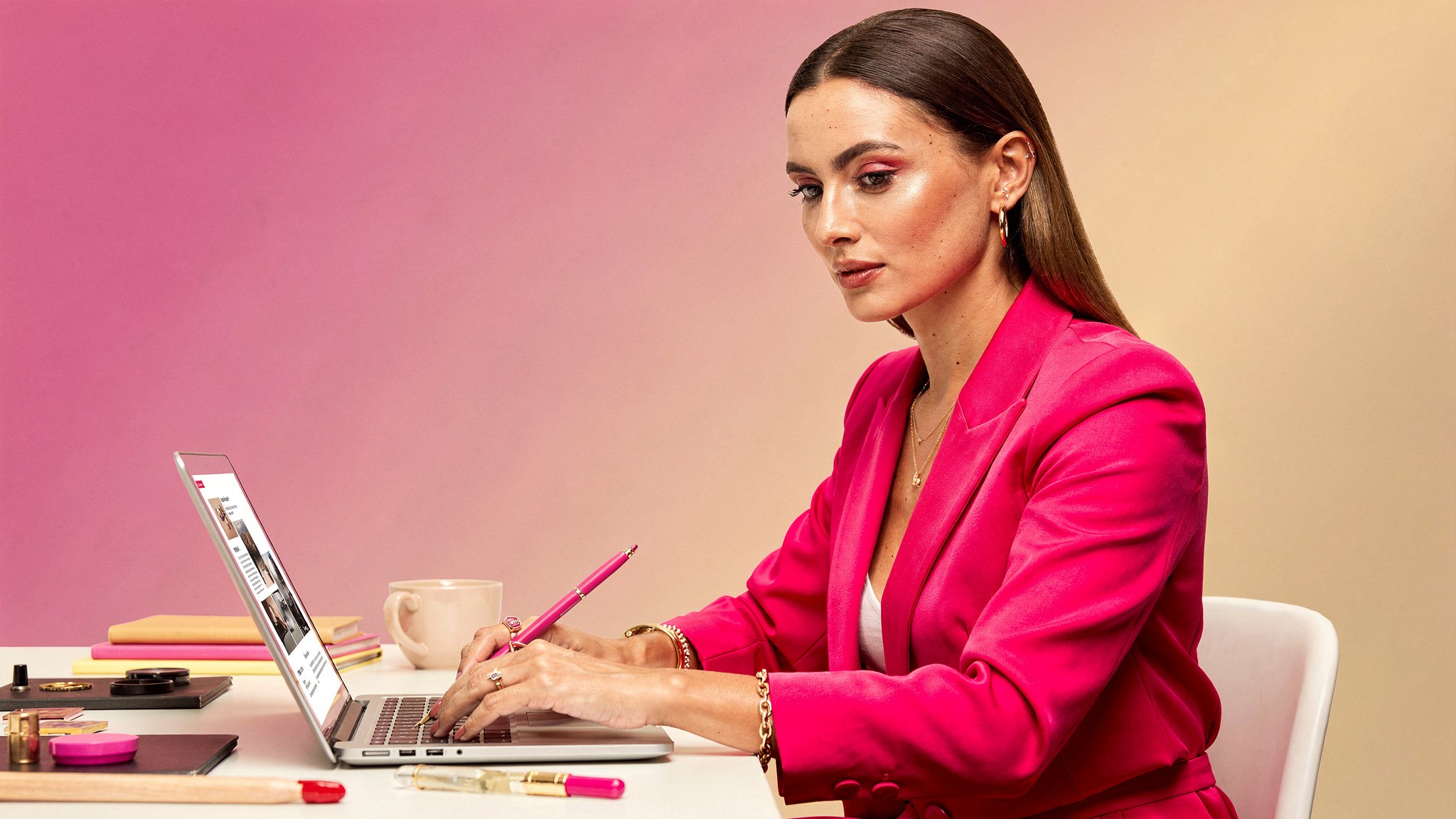 Creator at a desk choosing between photos on a laptop, selecting the best ai photos