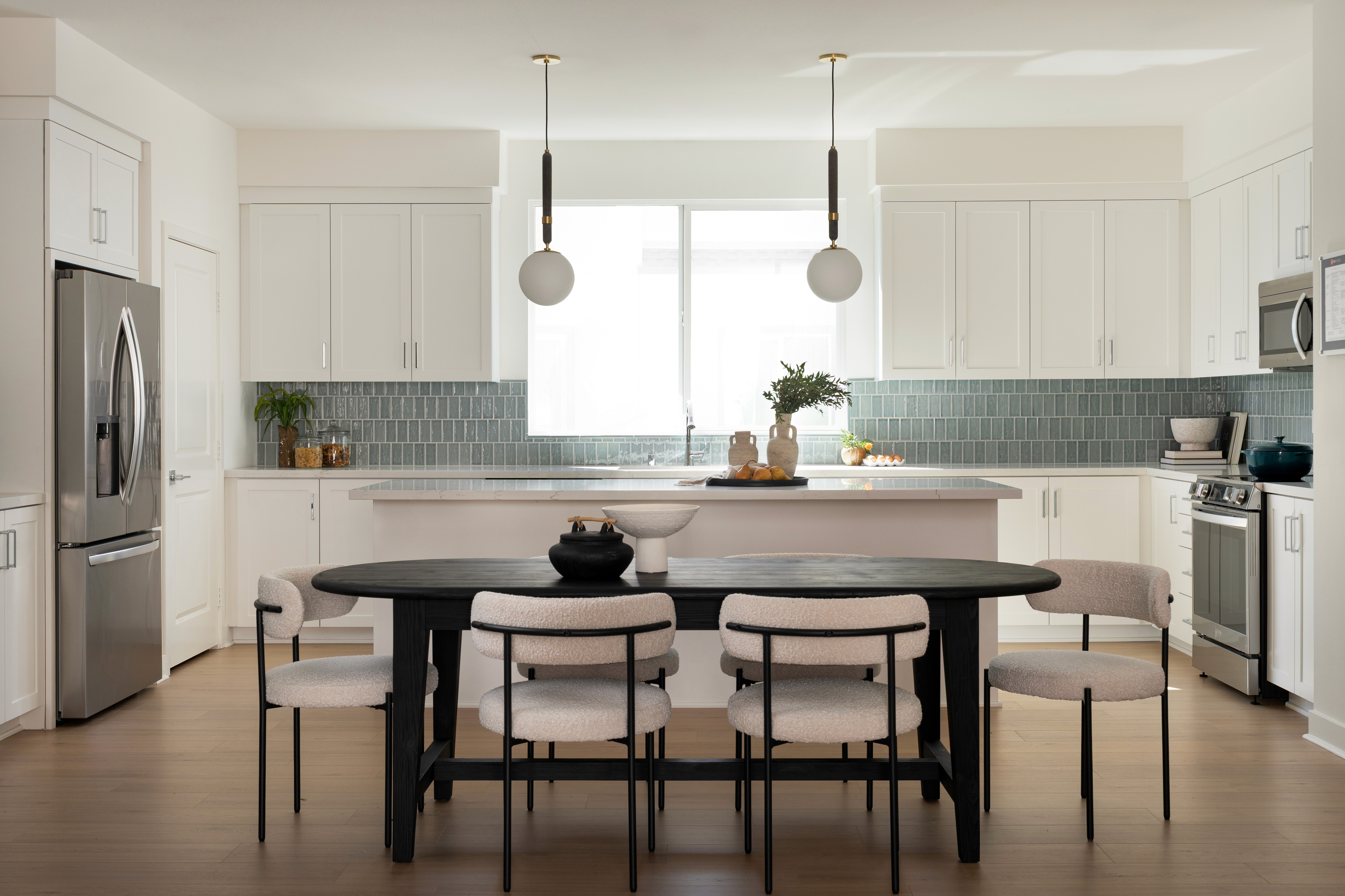 Dining area and kitchen with pendant lighting and decor
