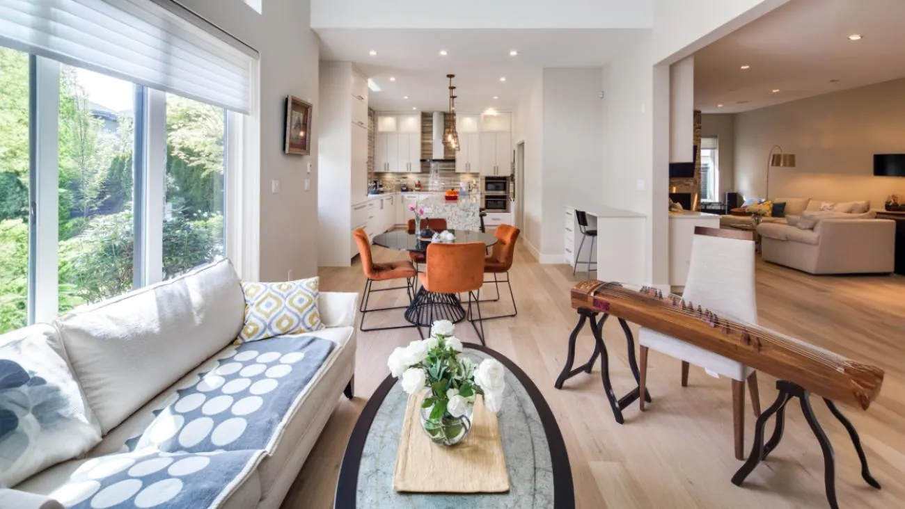 Open concept main floor showcasing seamless flow between living room, dining area, and gourmet kitchen with high-end finishes and hardwood throughout