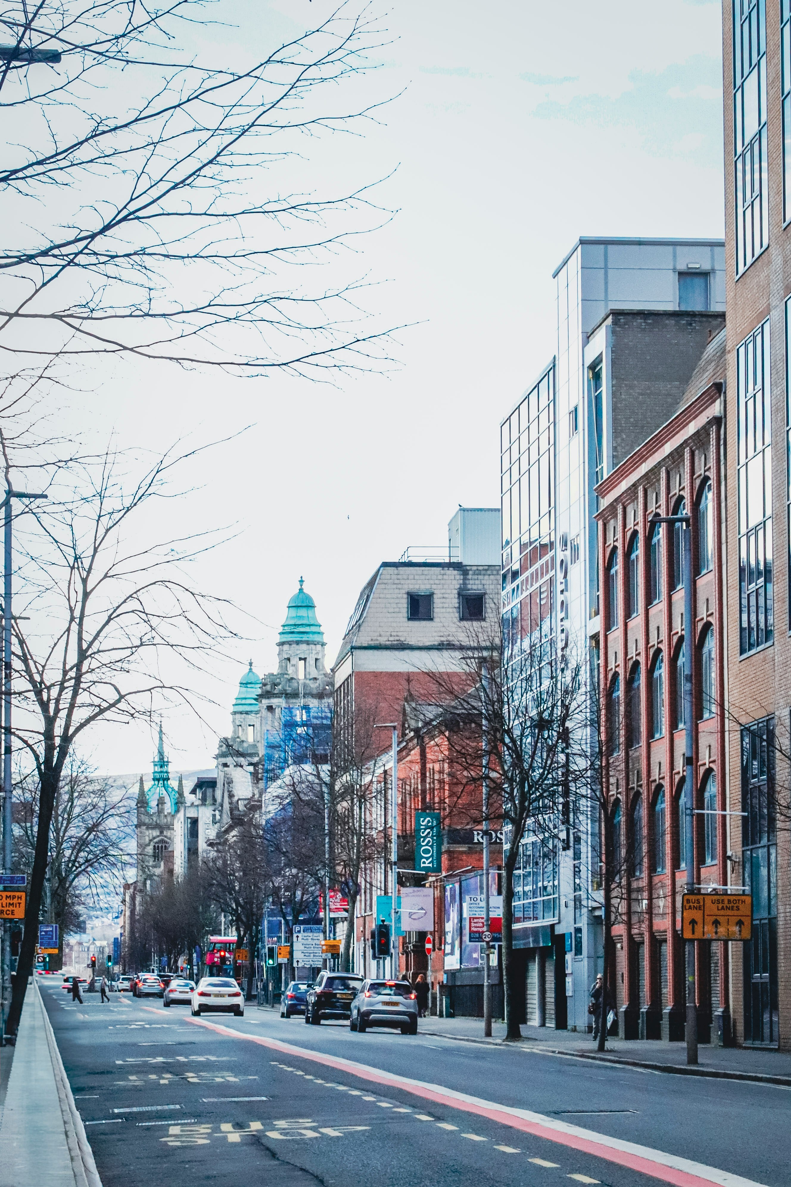 City street with historic buildings and cars.