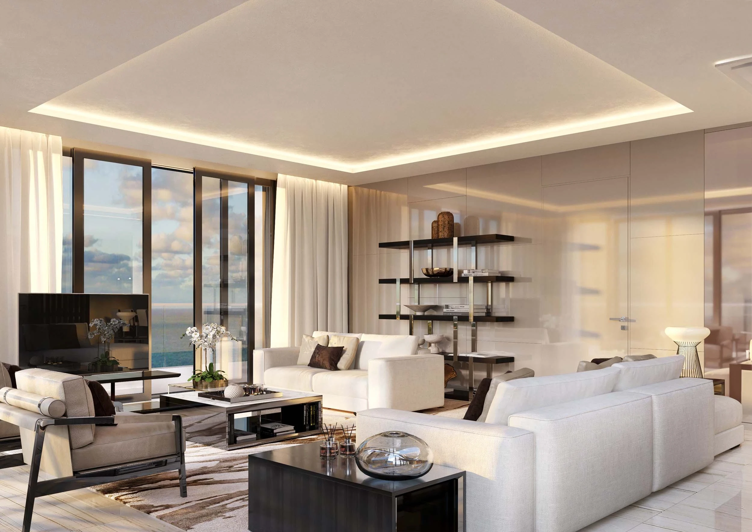 A modern living room with a sleek design featuring white sofas, a glass coffee table, and a large flat-screen TV. Reminiscent of luxurious beach villas, the room has floor-to-ceiling windows with ocean views, sheer curtains, and built-in shelves adorned with decorative items.