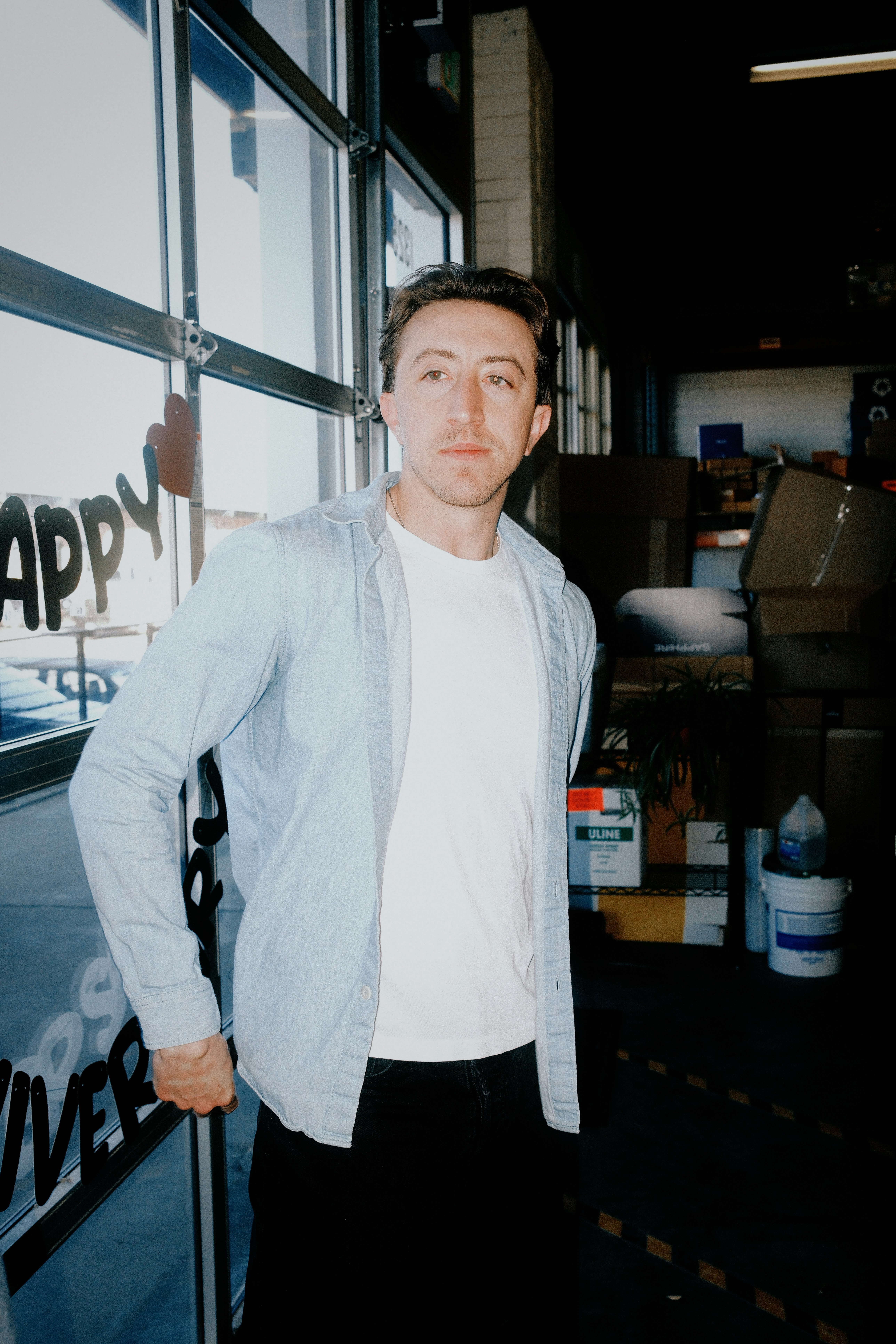 Man in casual clothing standing near a garage door.