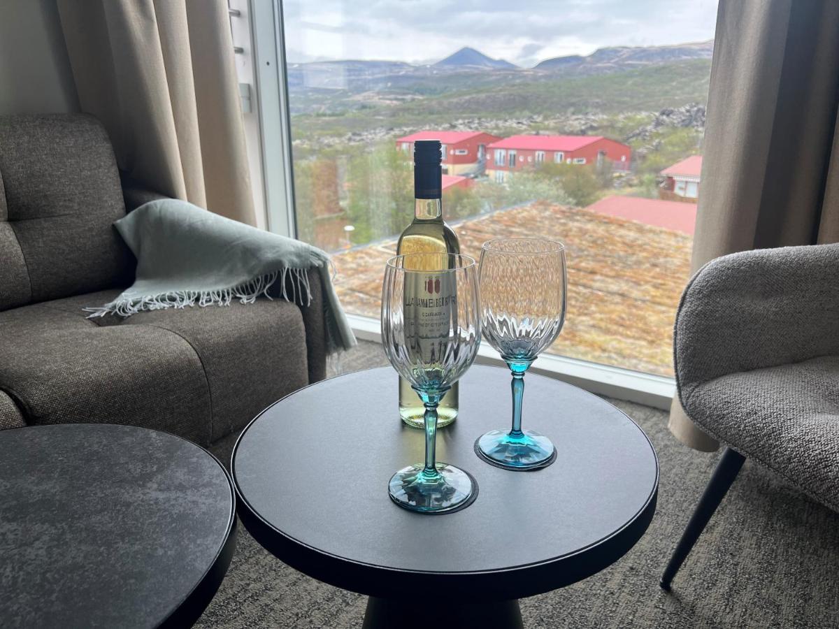 Spacious Triple Room interior at Hotel Bifröst with cozy bedding