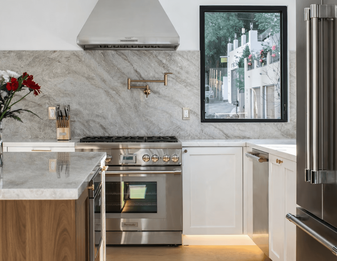 Modern hillside home with terracotta urn and mountain view