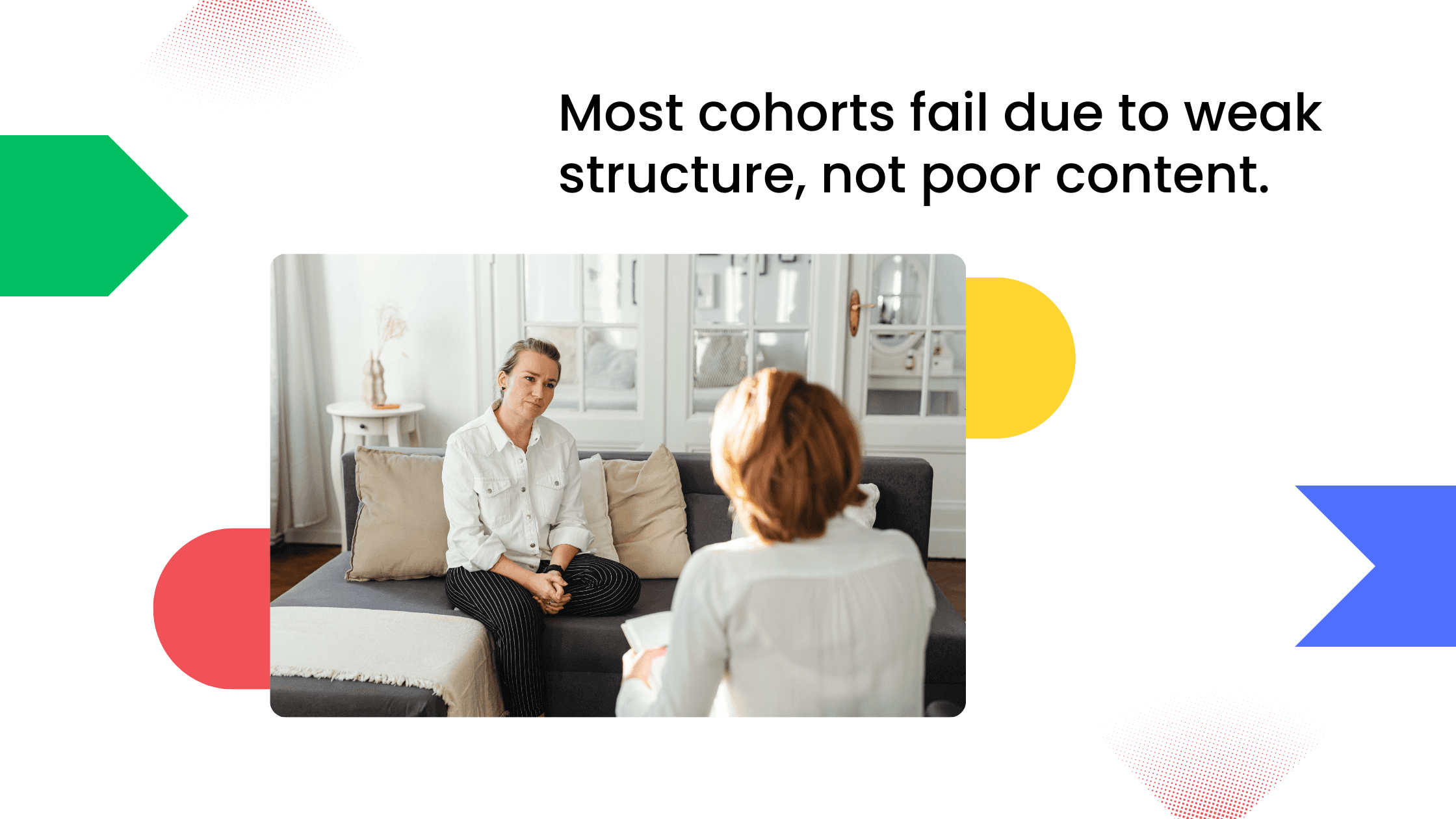 Two people seated on a couch in a face-to-face coaching conversation in a living room.