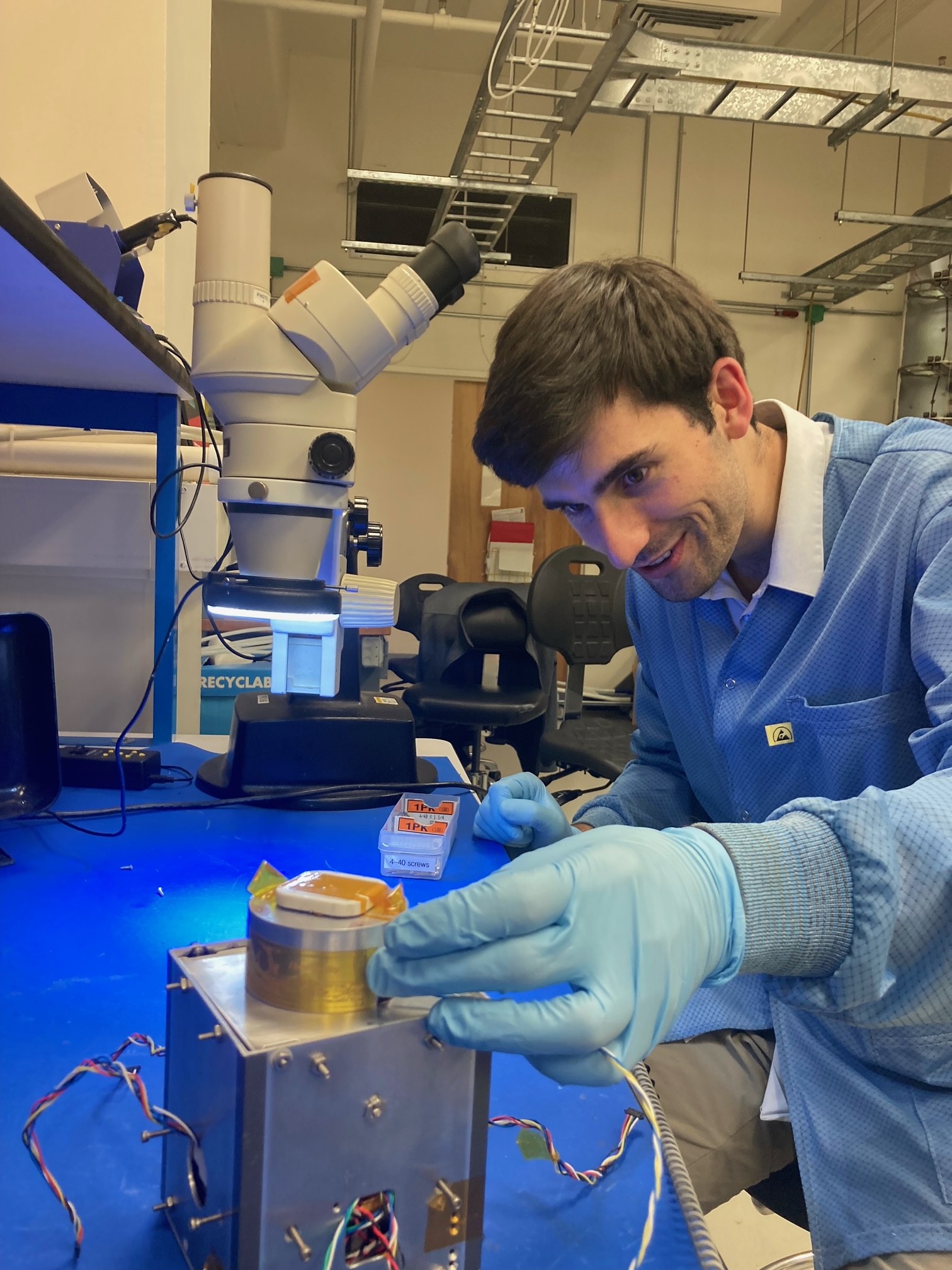 engineer applying the artwork to the satellite