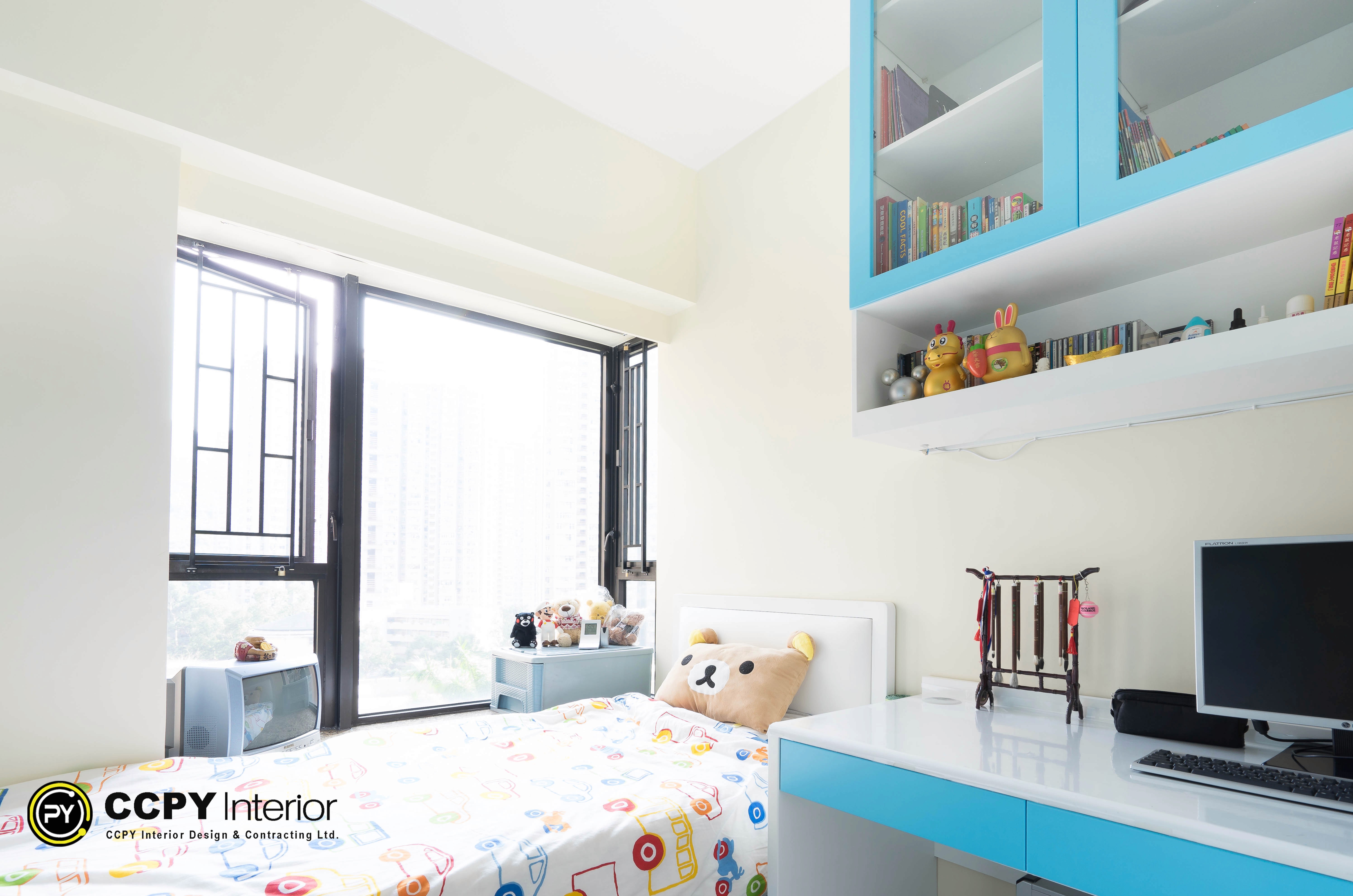 Vibrant blue shelving units and a minimalist desk define this organized children's bedroom at Castello Block3.
