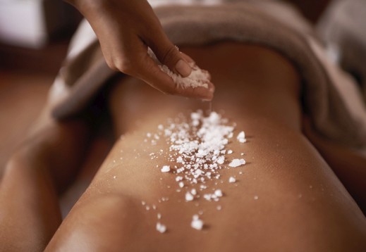 guest's back with scrub being applied on the body