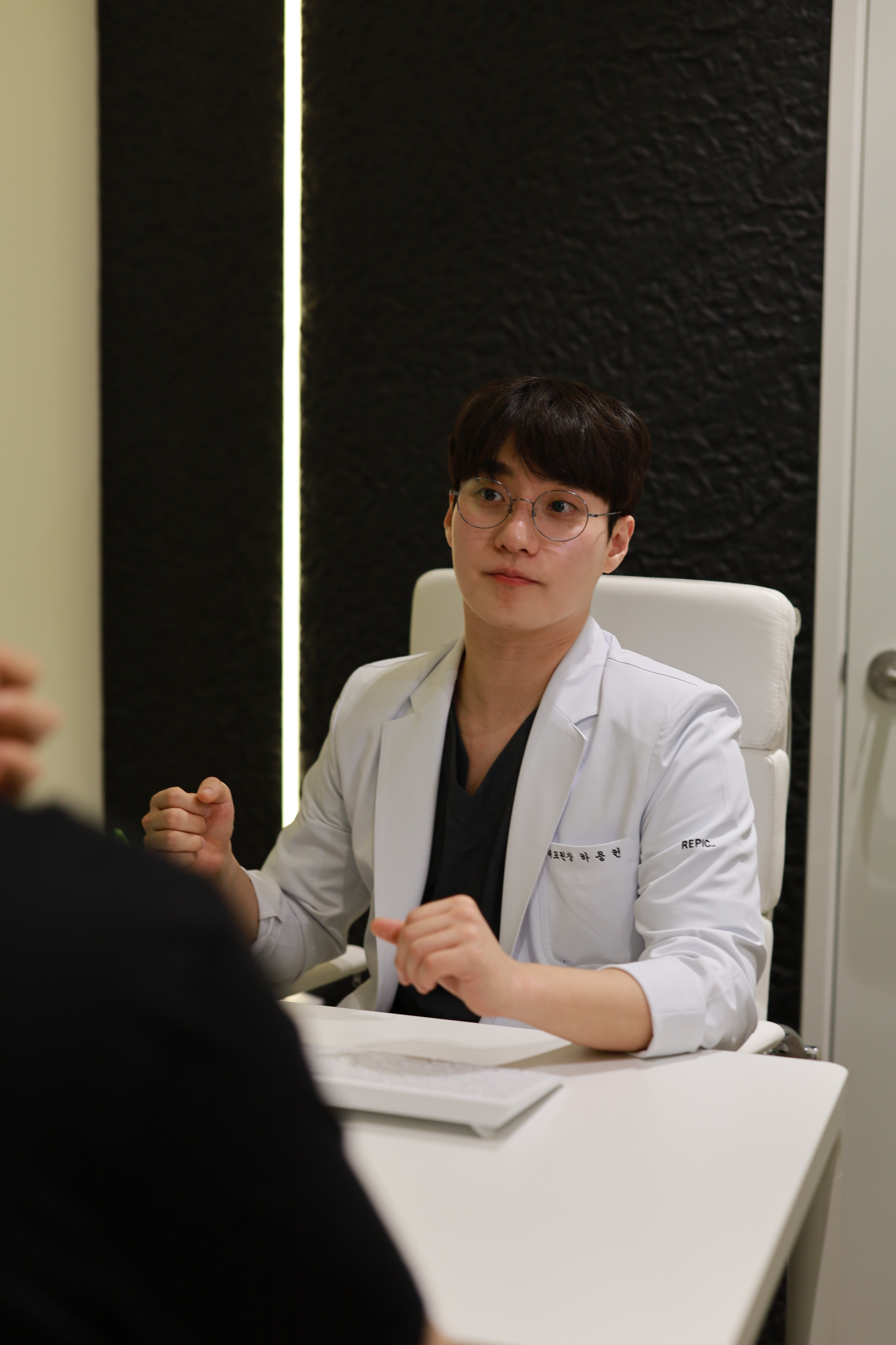 Dr. Yong-Heon Ha consulting with a patient