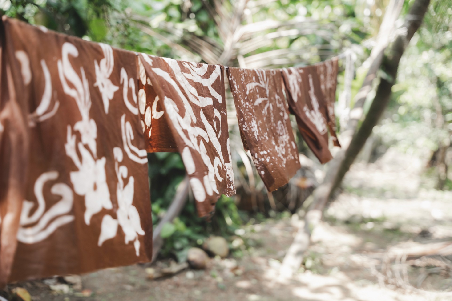 a group of women standing on top of a sandy beach