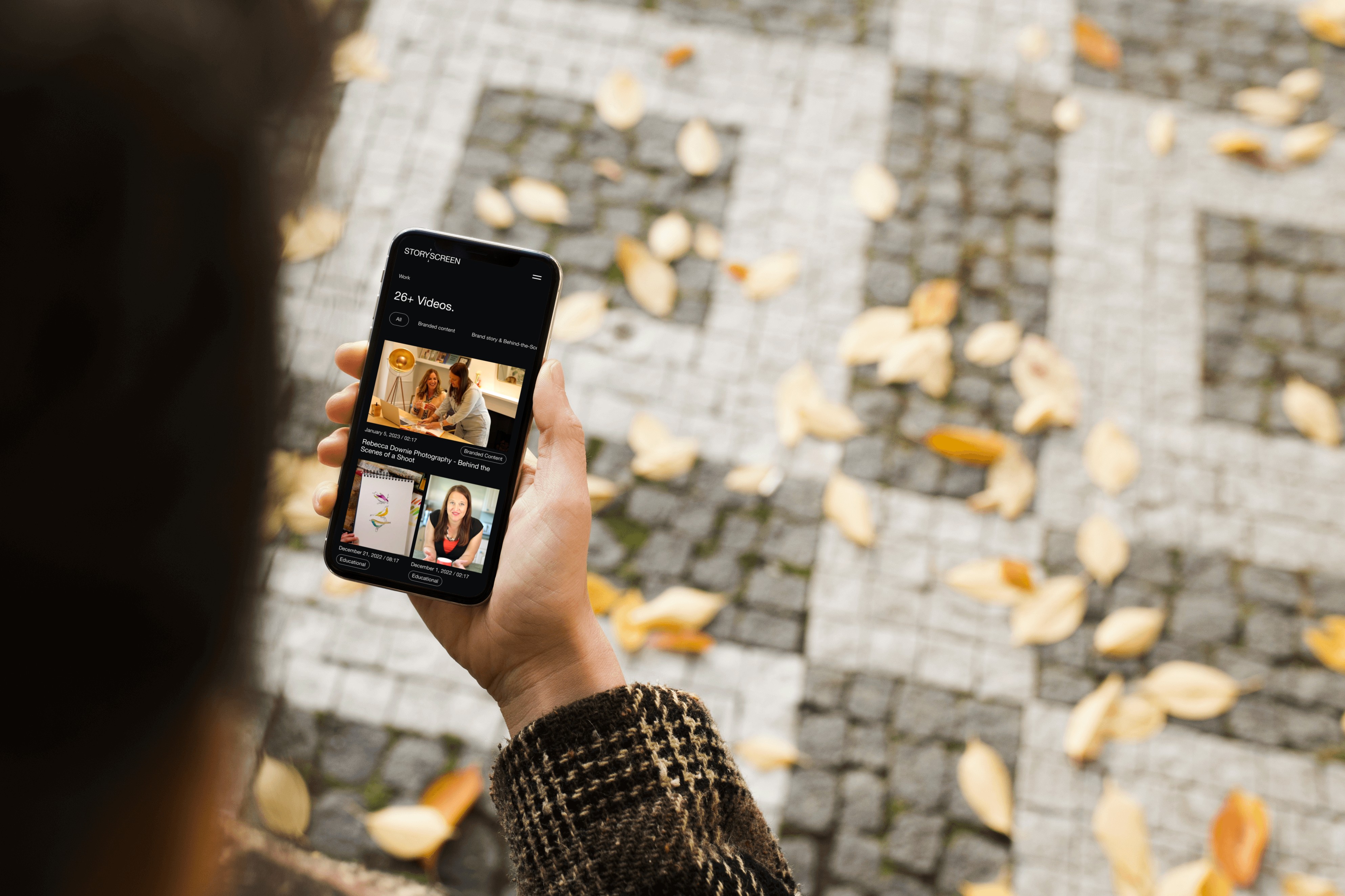 Modern home office setup with a monitor, ergonomic chair, keyboard, and indoor plants near a window with blinds.