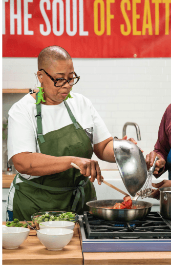 Seattle chef, Kristi Brown from That Brown Girl Cooks stirs a sauce pot on the Shooting Kitchen at Particle Studio in Seattle.