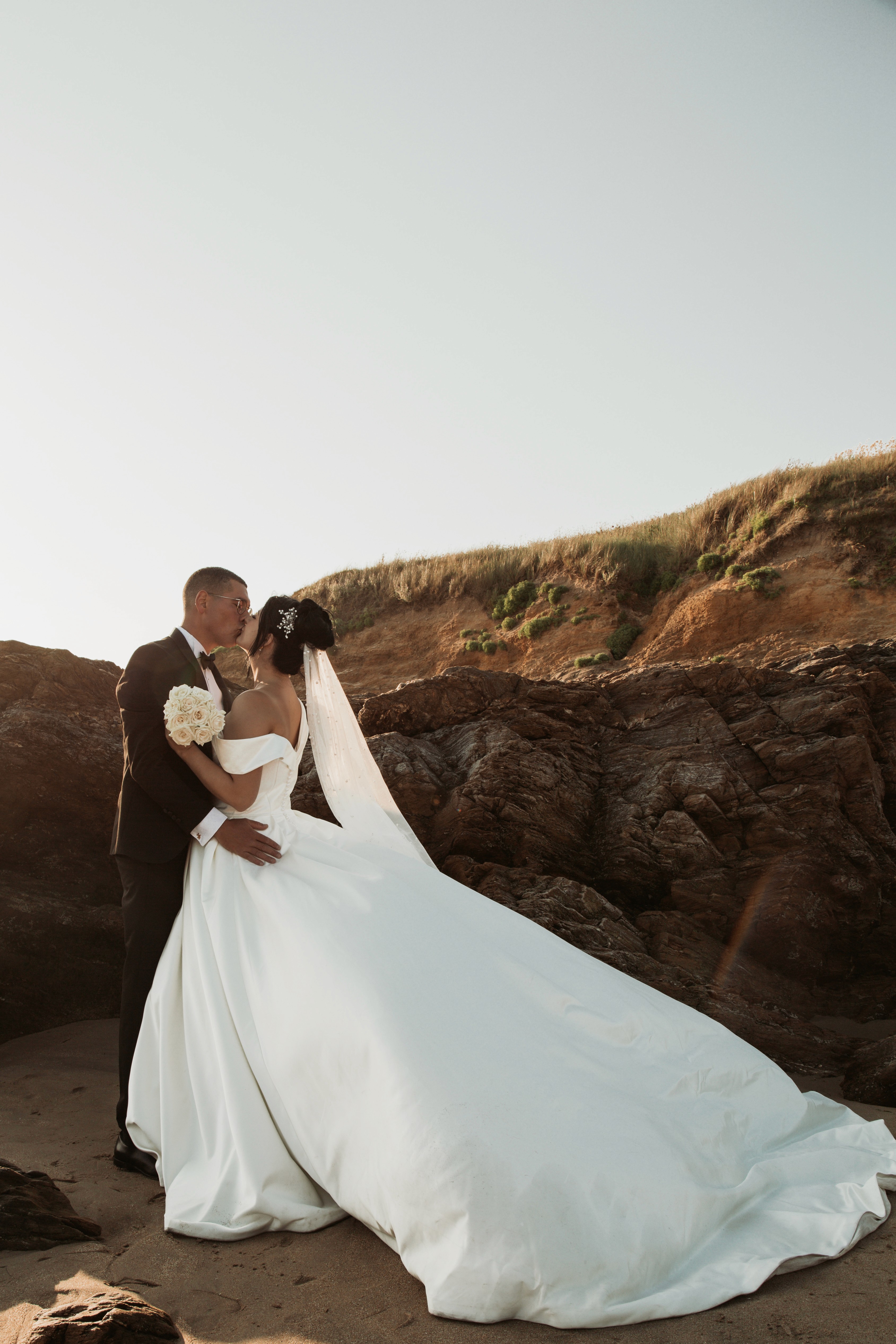Stylish individual with platinum blonde hair, sunglasses, and leather outfit