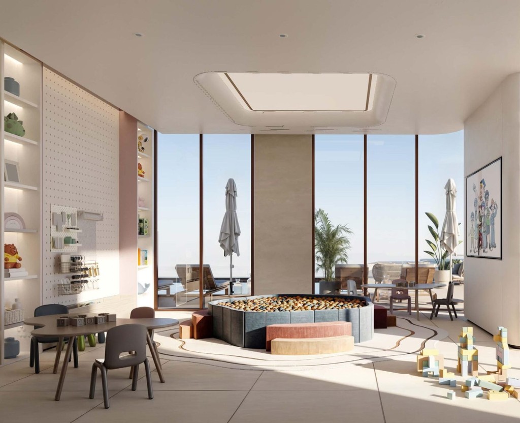 Stylish living room at Flora Shore Beachfront Residences, with large windows offering a city view.